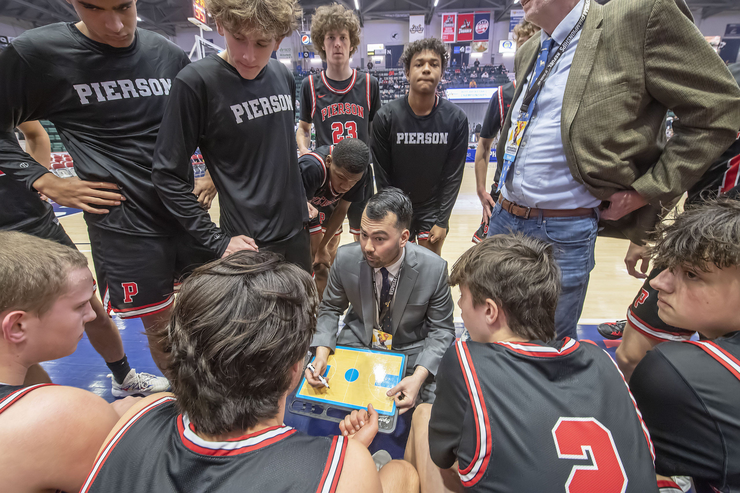 Pierson head coach Will Fujita draws up a play late in the game.    MICHAEL HELLER