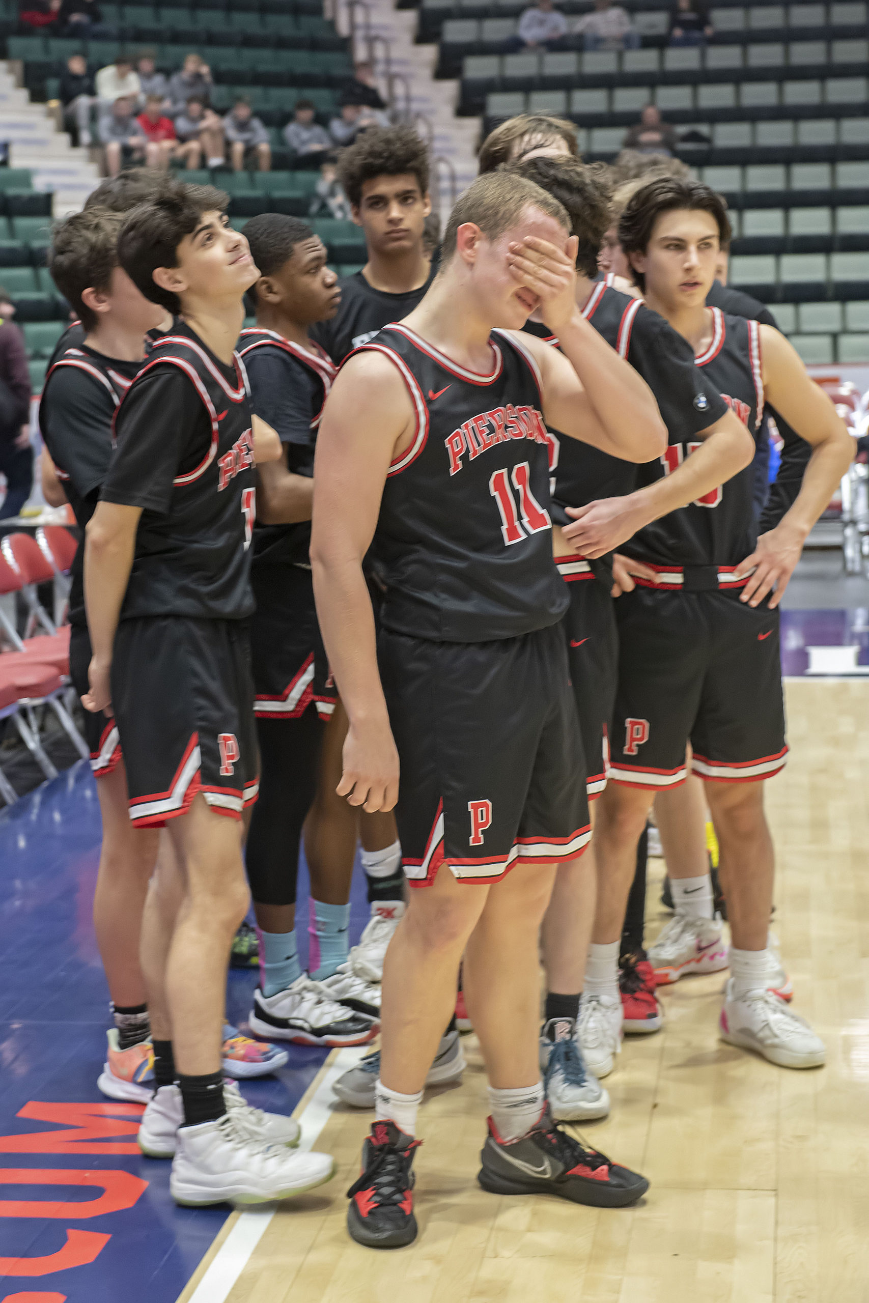 Logan Hartstein and the rest of the Whalers react after the final whistle blows in their 66-62 loss to Newfield on Friday.    MICHAEL HELLER