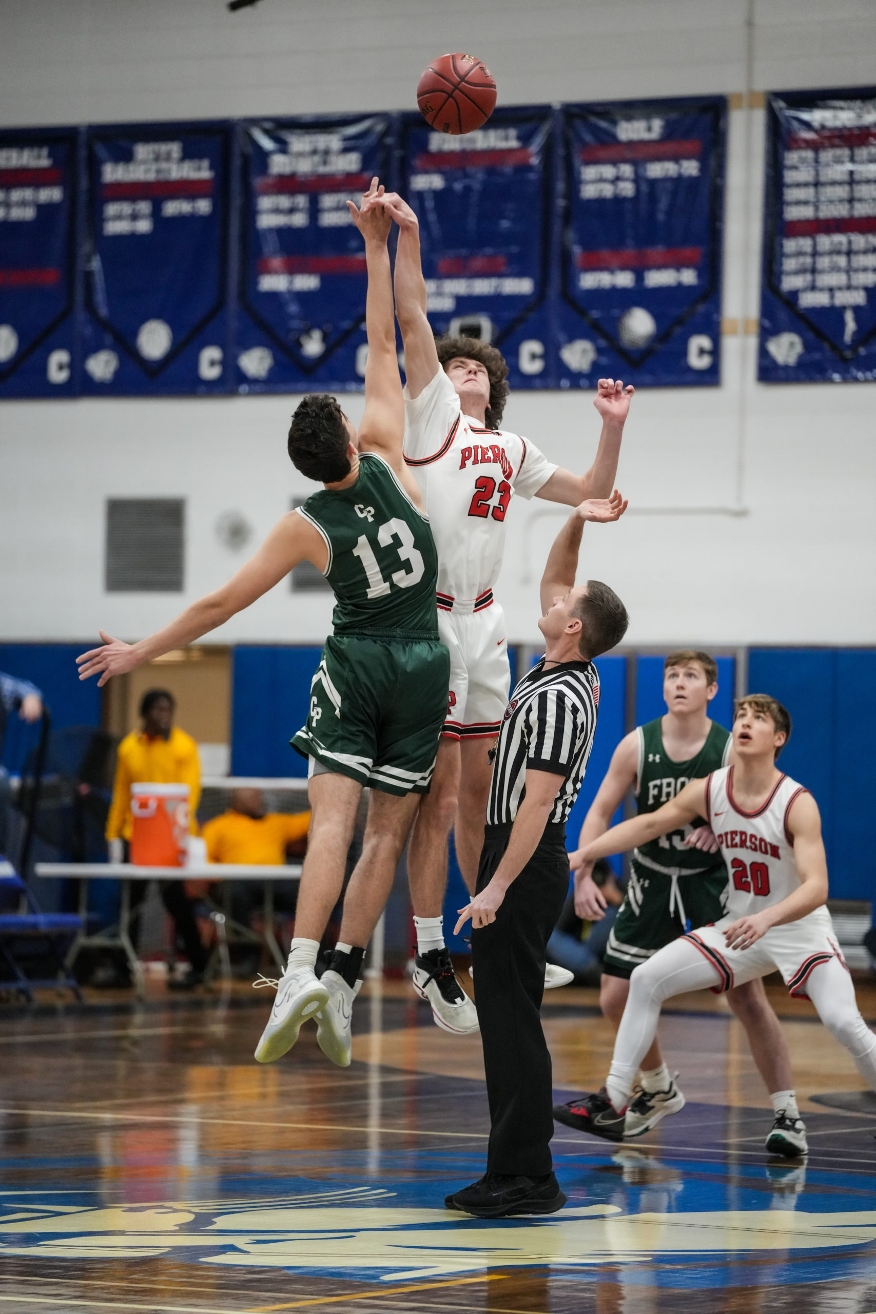 Pierson senior Charlie Culver and Carle Place senior James McKeough take the opening tip-off of Wednesday's Long Island Class C Championship at Centereach High School.   RON ESPOSITO