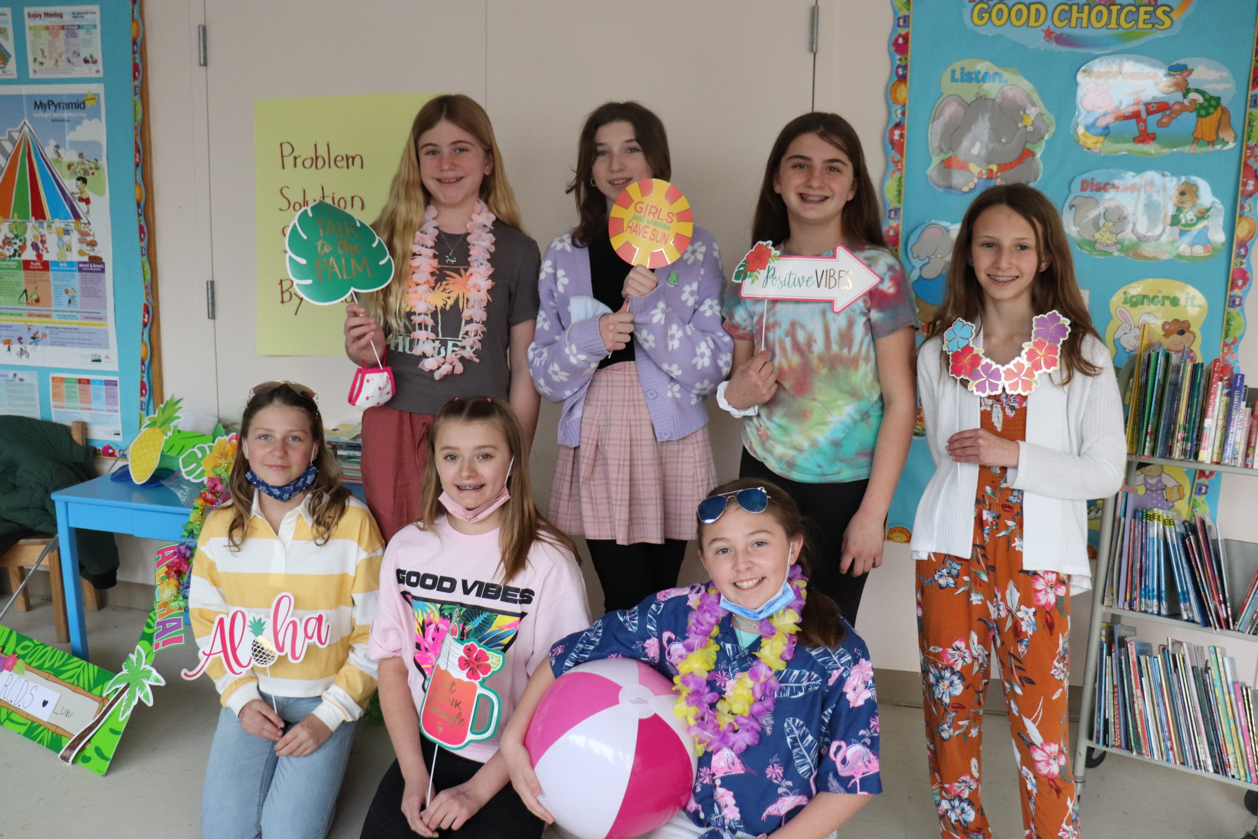 Sixth-grader at Raynor Country Day School celebrate Read Across America Week with a reading luau last week.