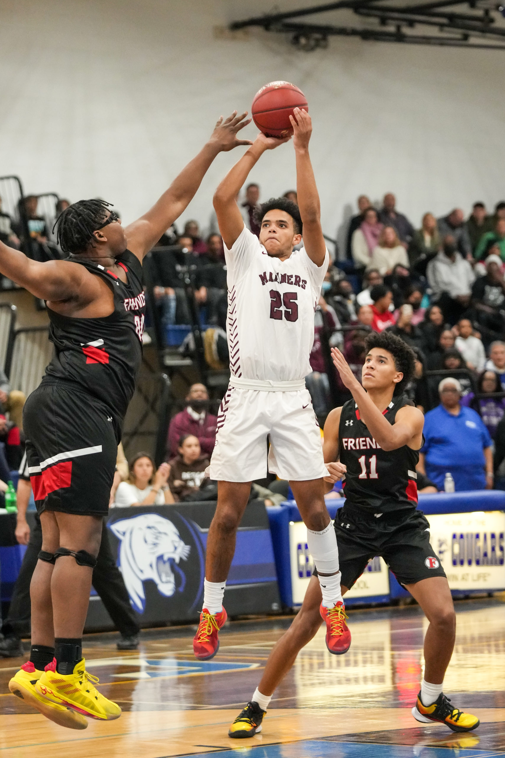 Southampton senior co-captain LeBron Napier shoots over C.J. Williams of Friends Academy.    RON ESPOSITO