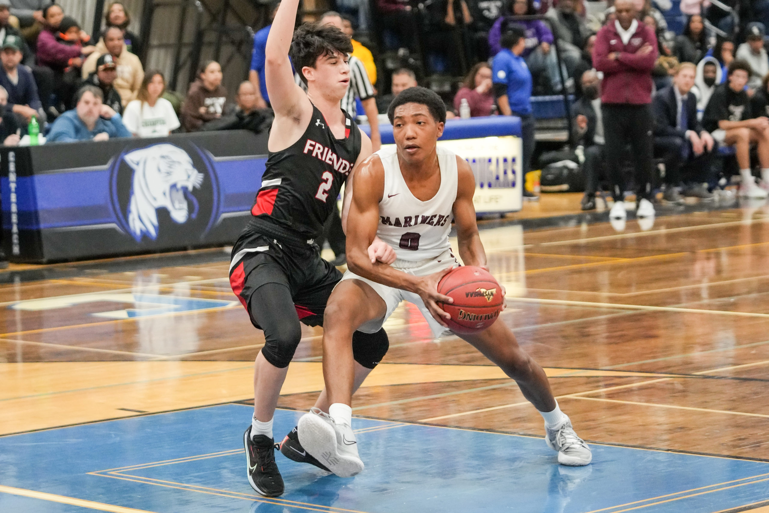 Mariner Naevon Jenkins drives on Quaker Gabe Ferenez.   RON ESPOSITO