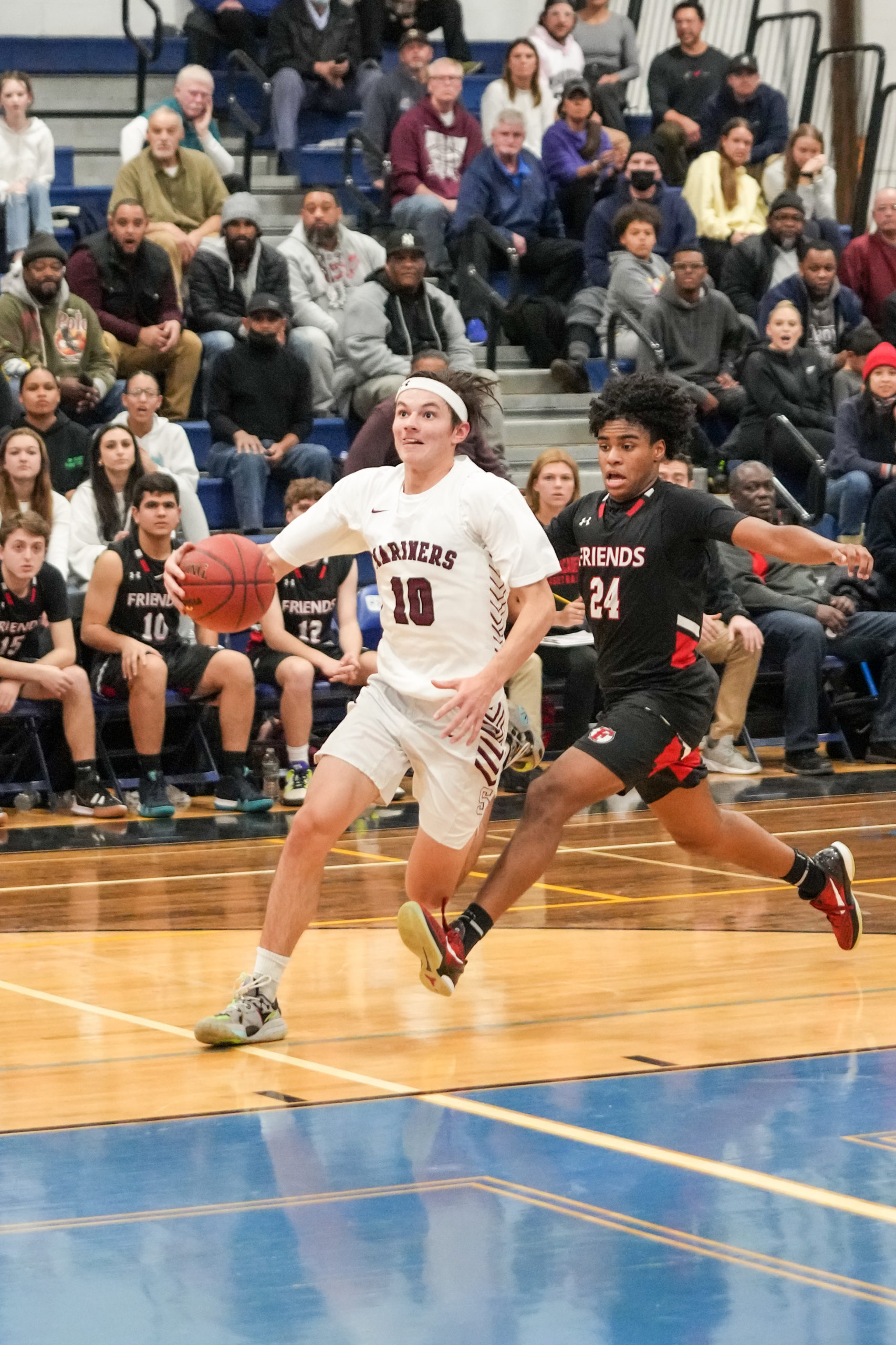 Senior Mariner Andrew Venesina gets by Friends Academy's Malachi Polson.