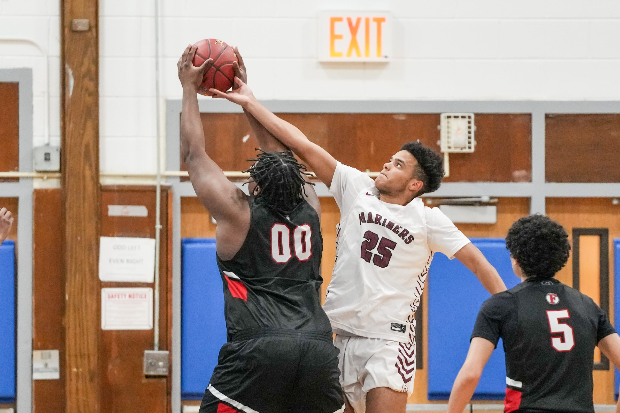 Southampton's LeBron Napier gets a hand on a shot from Friends Academy's C.J. Williams.   RON ESPOSITO