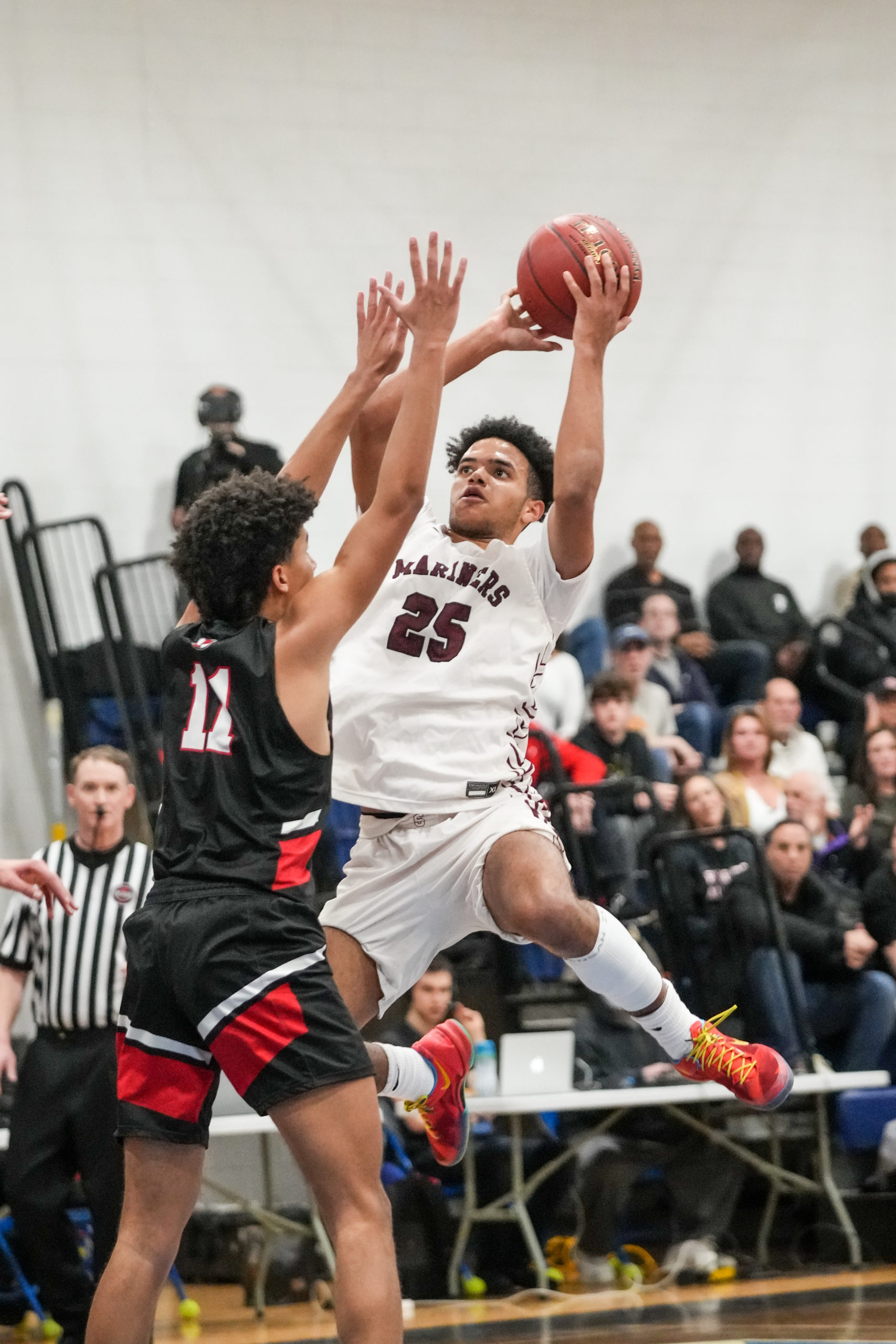 Southampton senior co-captain LeBron Napier shoots over Logan Mott of Friends Academy.    RON ESPOSITO