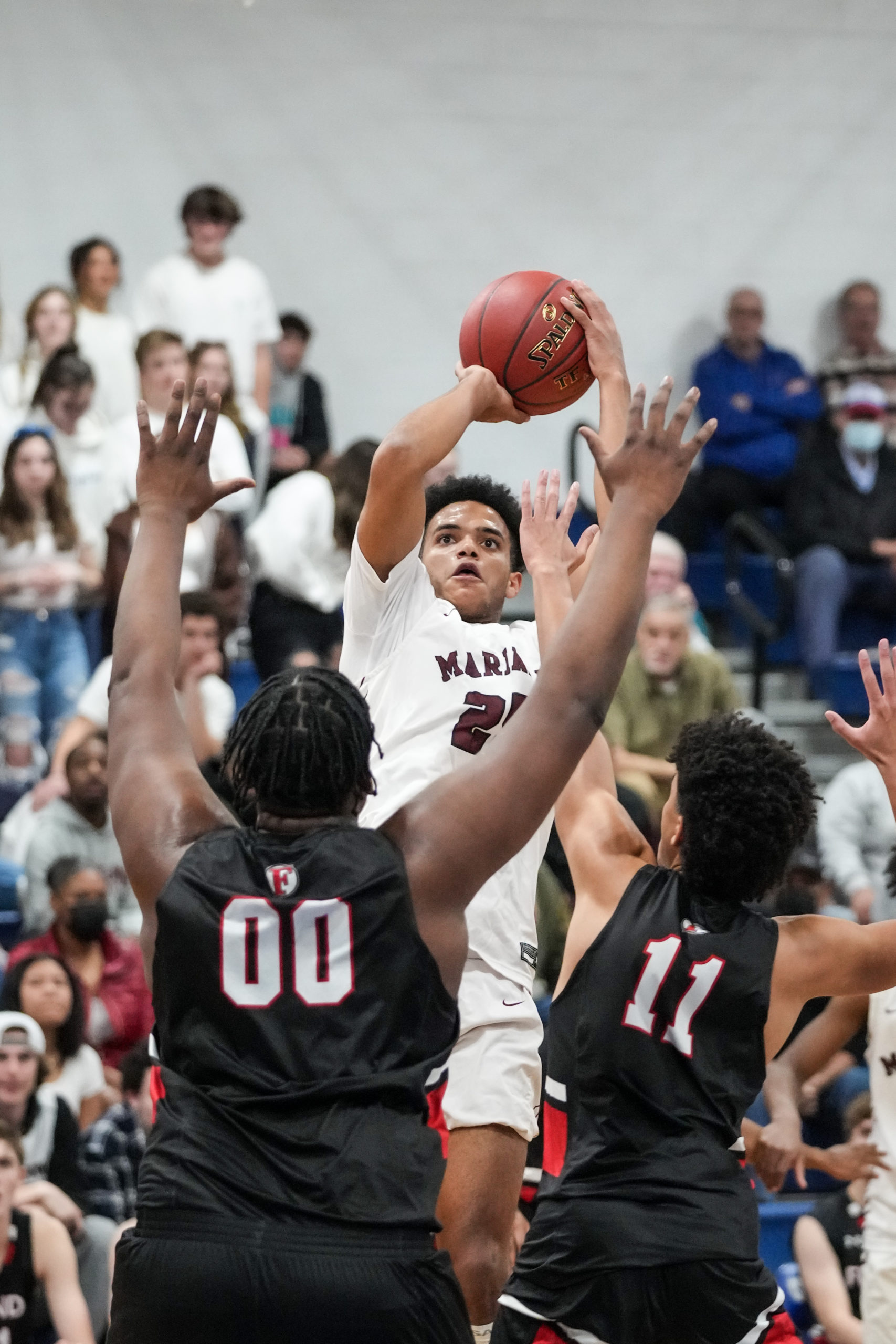 Senior Mariner LeBron Napier tries to shoot over Quakers C.J. Williams (00) and Logan Mott.   RON ESPOSITO