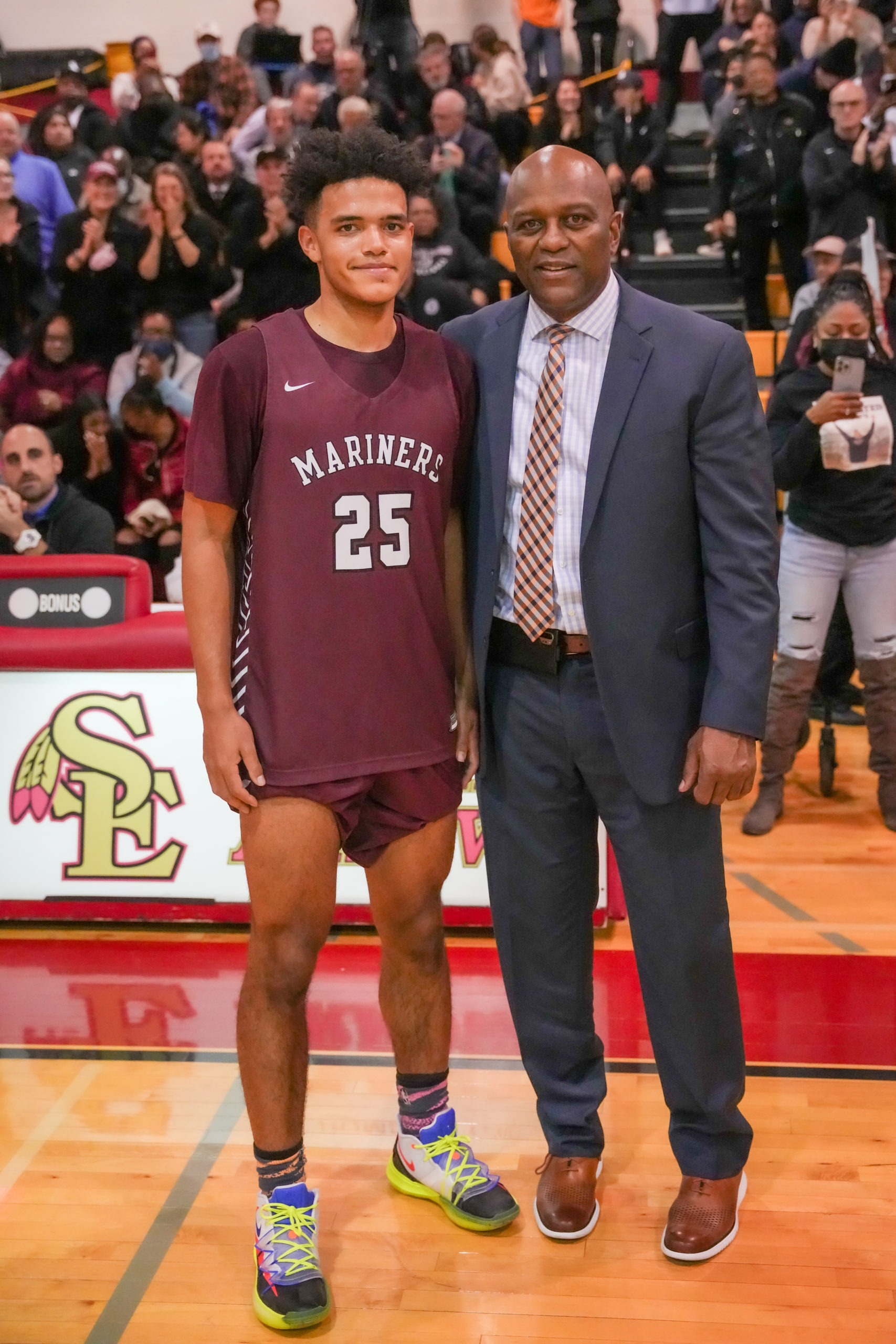 LeBron Napier with his head coach Herm Lamison after scoring his 1,000th career point.   RON ESPOSITO