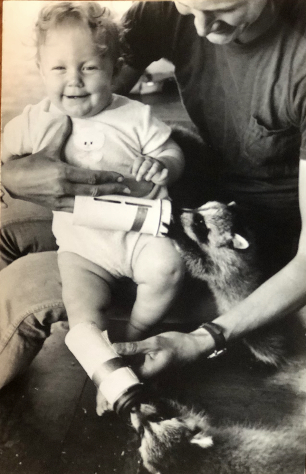 Patsy Topping holding her daughter, Gretchen, will also bottle-feeding baby raccoons she had rescued. Her love of dogs, horses and other animals was a big feature of Topping's personality.  COURTESY THE TOPPING FAMILY