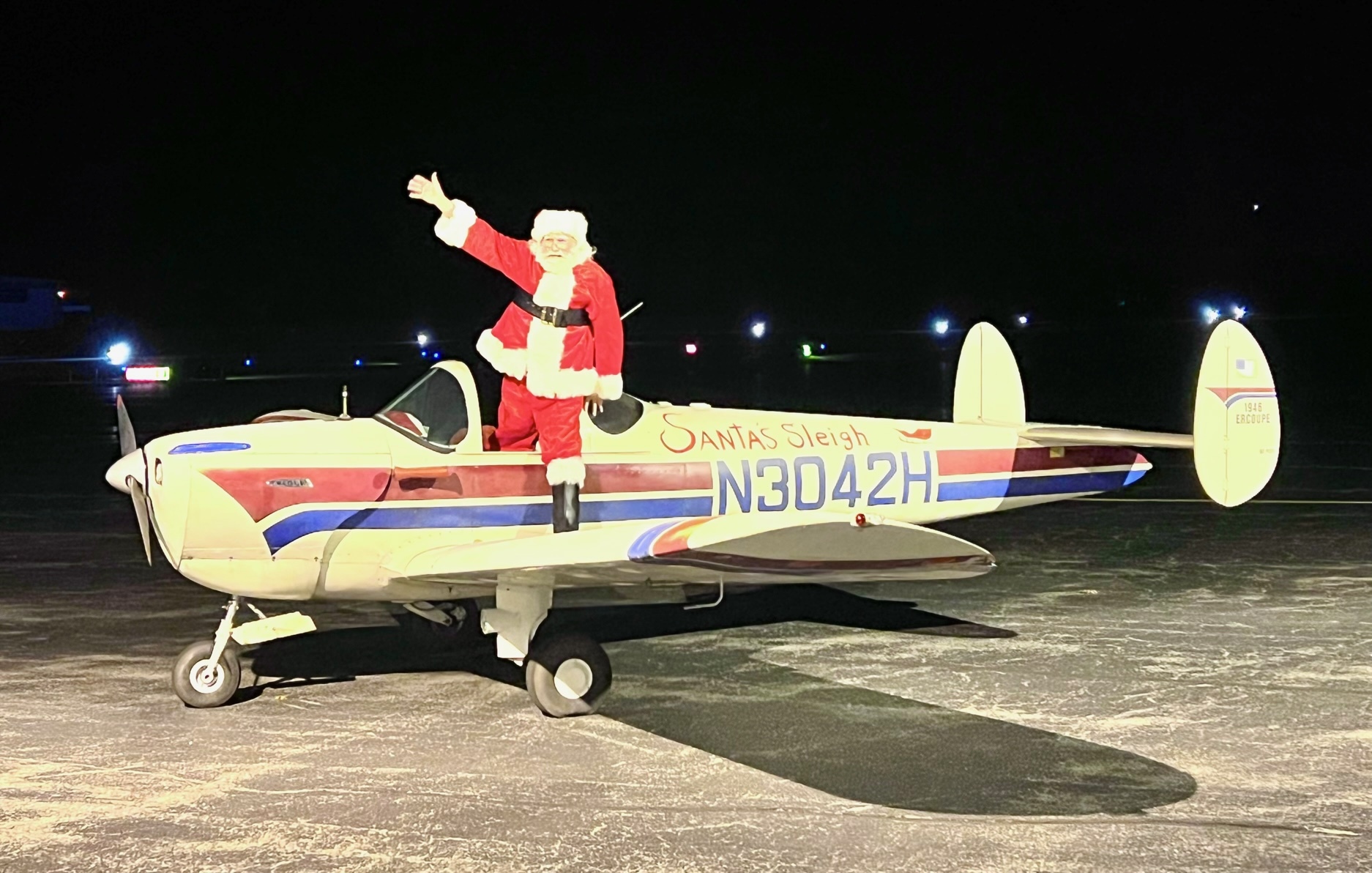'Santa' and the 1947 Ercoupe he flew in to East Hampton Airport last December for the airport's annual holiday party. A local pilot, Kathryn Slye, pointed out to the Town Board this week that part of their proposal would limit small planes like this one in the same way it limits commercial helicopters.
