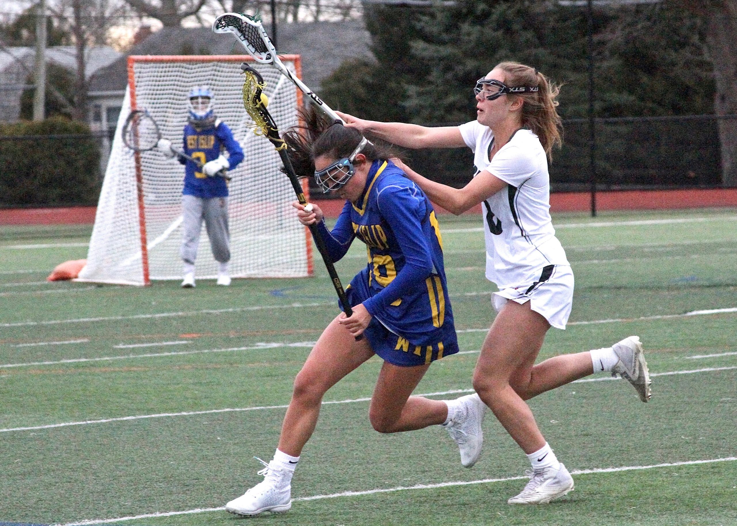 Westhampton Beach eighth-grader Ava Derby checks a stick in an attempt to force a turnover. DESIRÉE KEEGAN