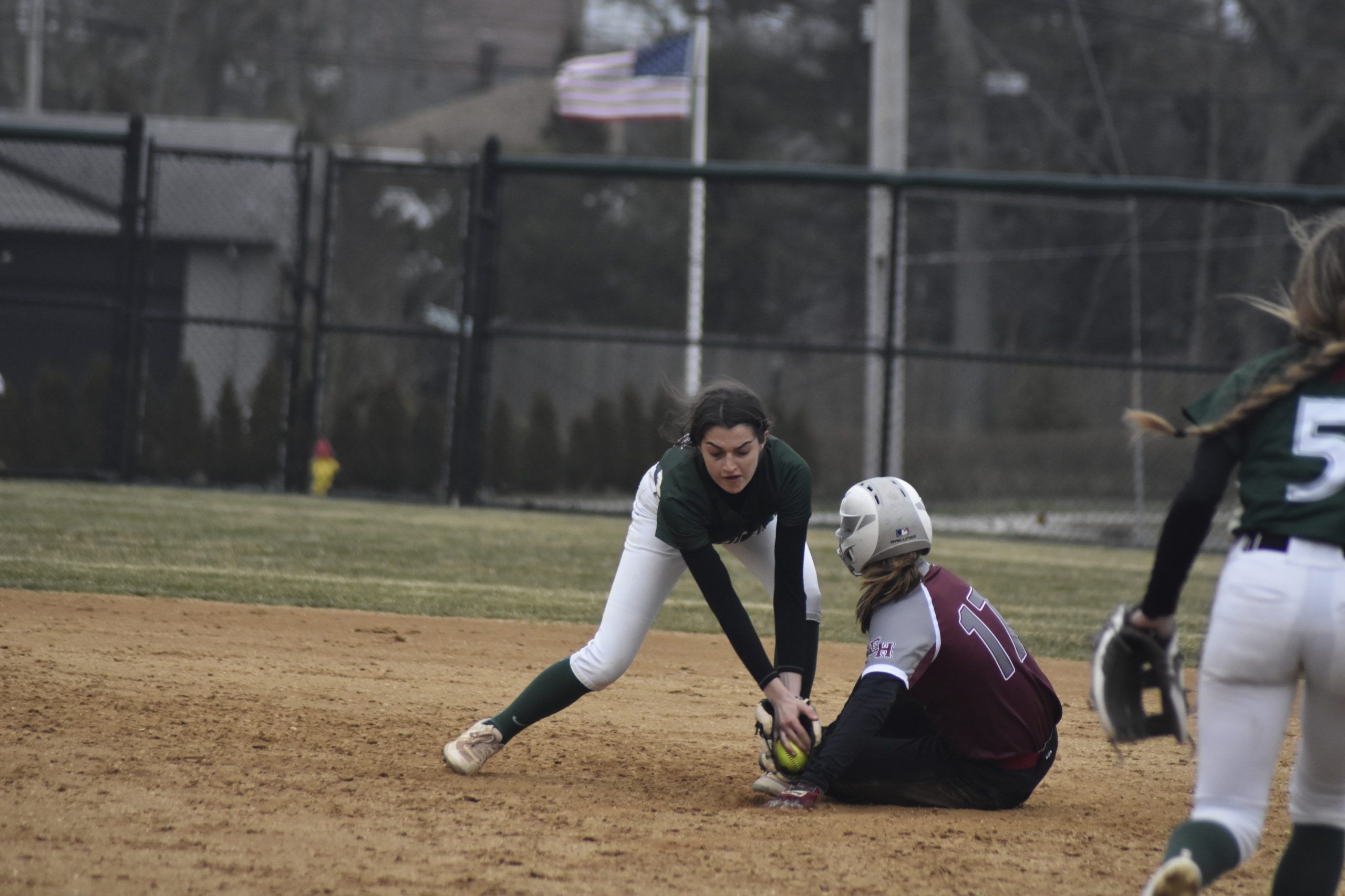 Westhampton Beach shortstop Allie Parascandola tries to tag out East Hampton's Susia DiSunno who slides in safely ahead of the throw.    DREW BUDD