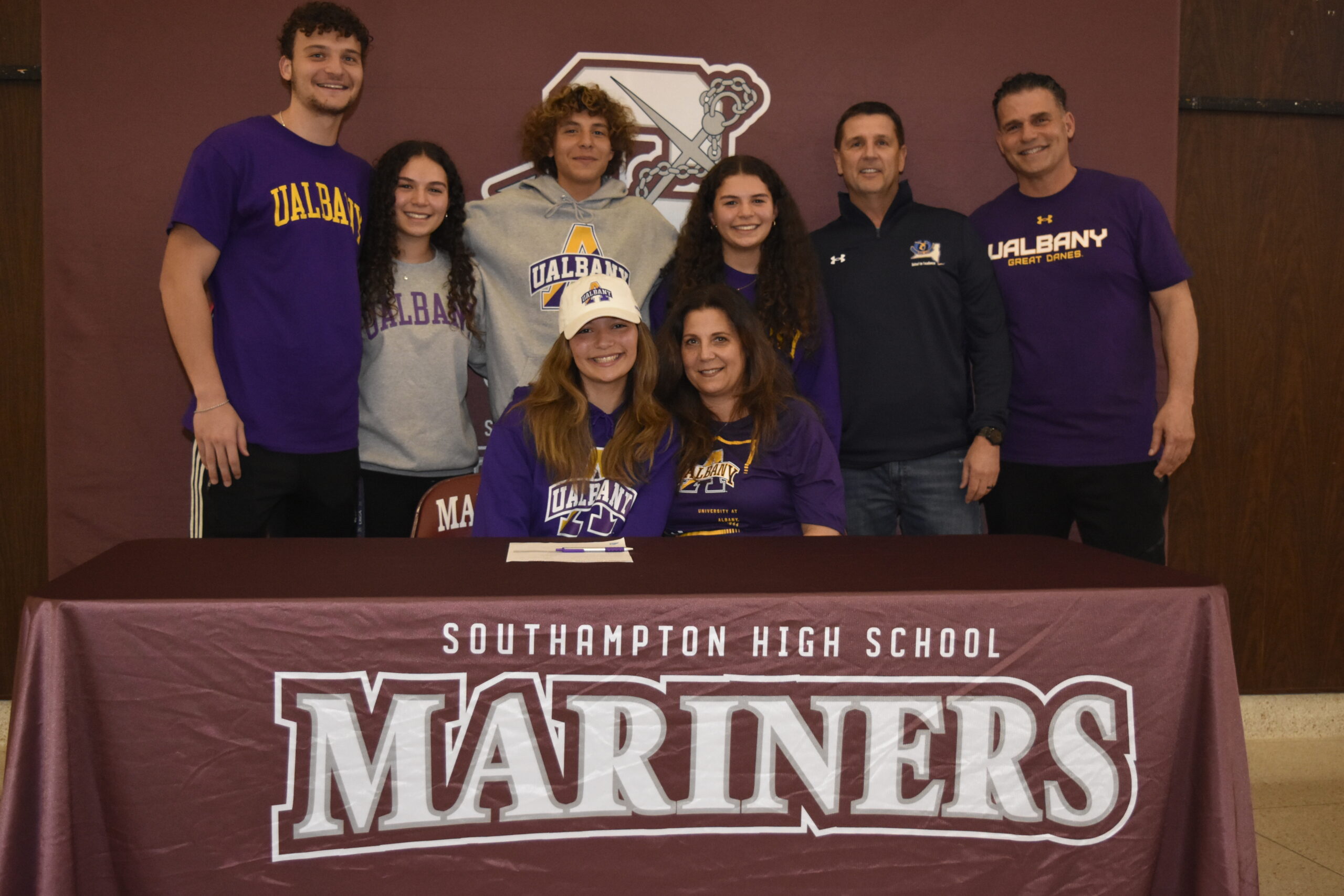 Gabriella Arnold, surrounded by her family and athletic director Darren Phillips, signed her letter of intent to run track at the University of Albany on April 1.    DREW BUDD