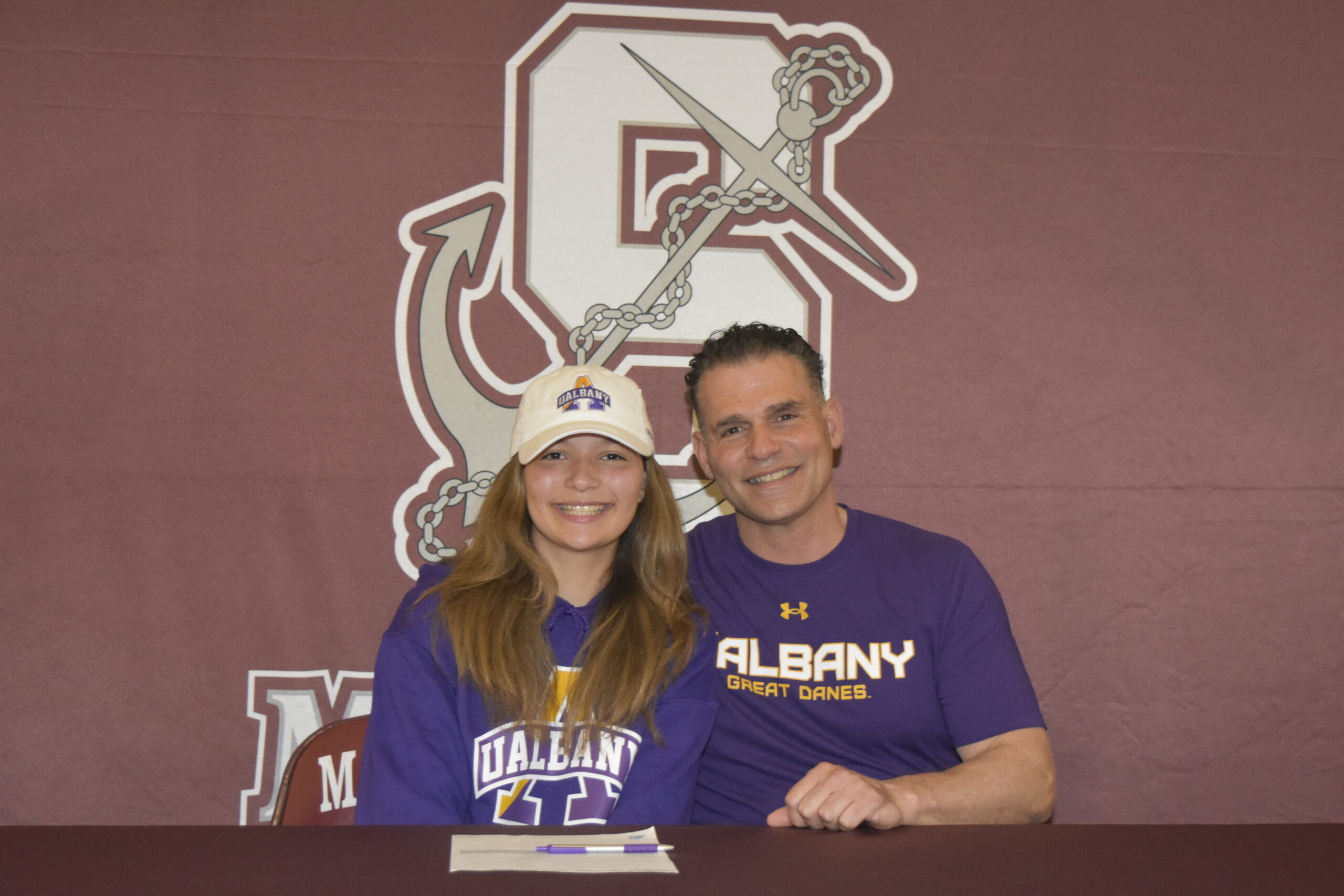 Gabriella Arnold, with her track coach and father Eddie Arnold, signed her letter of intent to run track at the University of Albany on April 1.    DREW BUDD