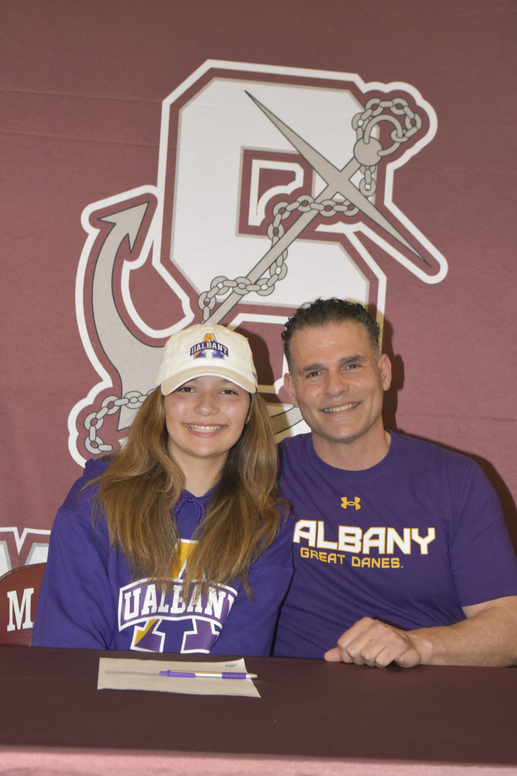 Gabriella Arnold, with her track coach and father Eddie Arnold, signed her letter of intent to run track at the University of Albany on April 1.    DREW BUDD