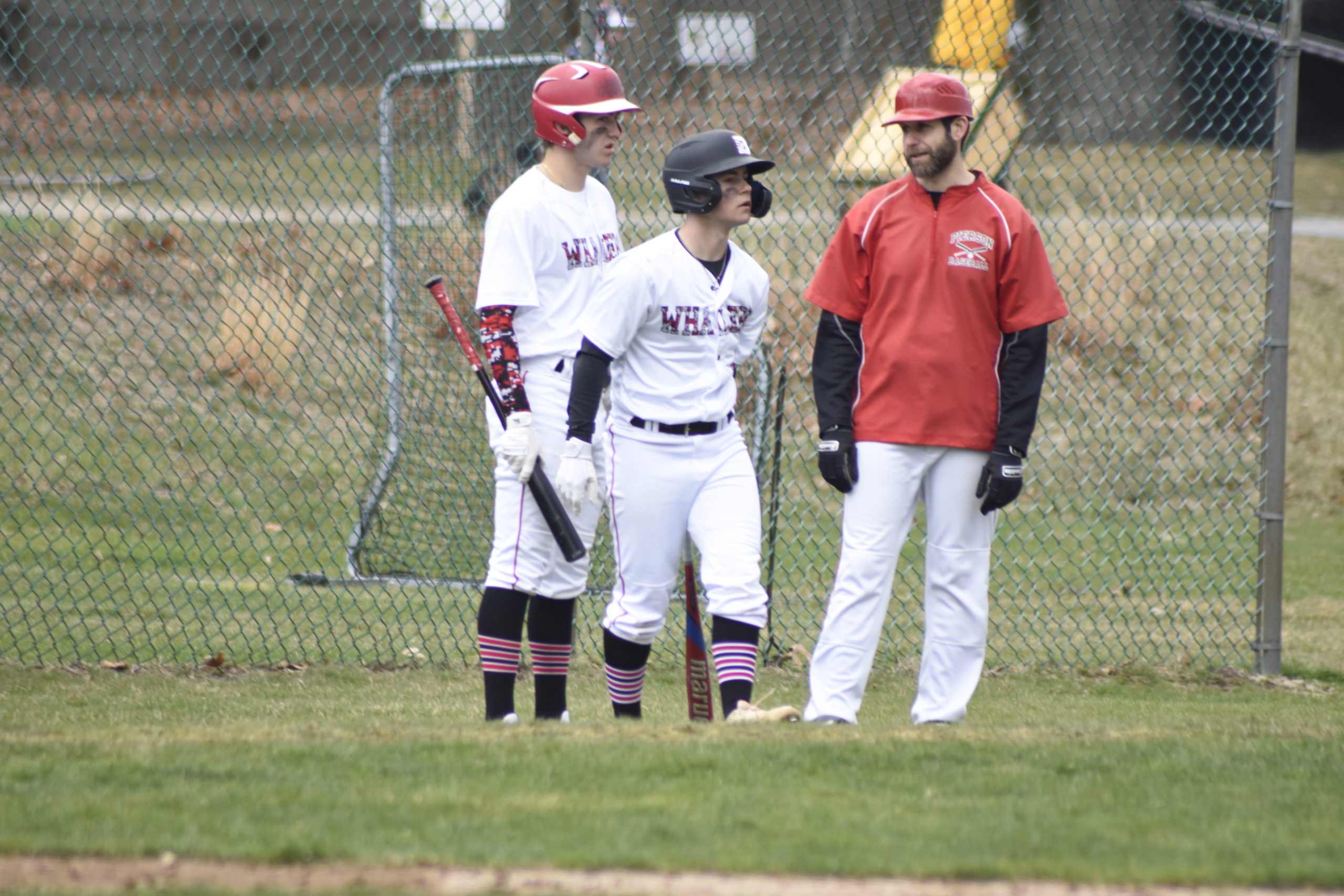 Reed Kelsey, left, Christian Pantina and head coach Jonathan Schwartz talk during a Shelter Island mound visit.    DREW BUDD