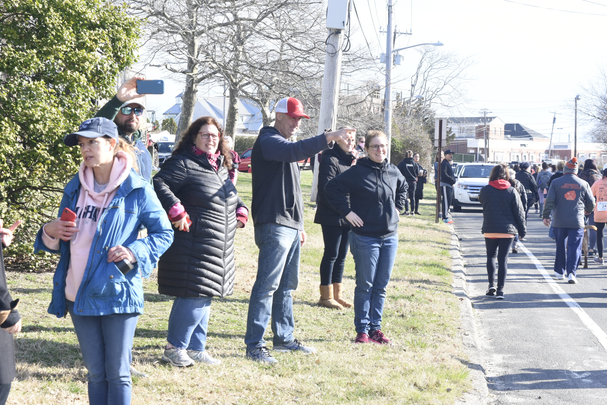 Onlookers, like Matt Malone, encourage those running and walking.   DREW BUDD