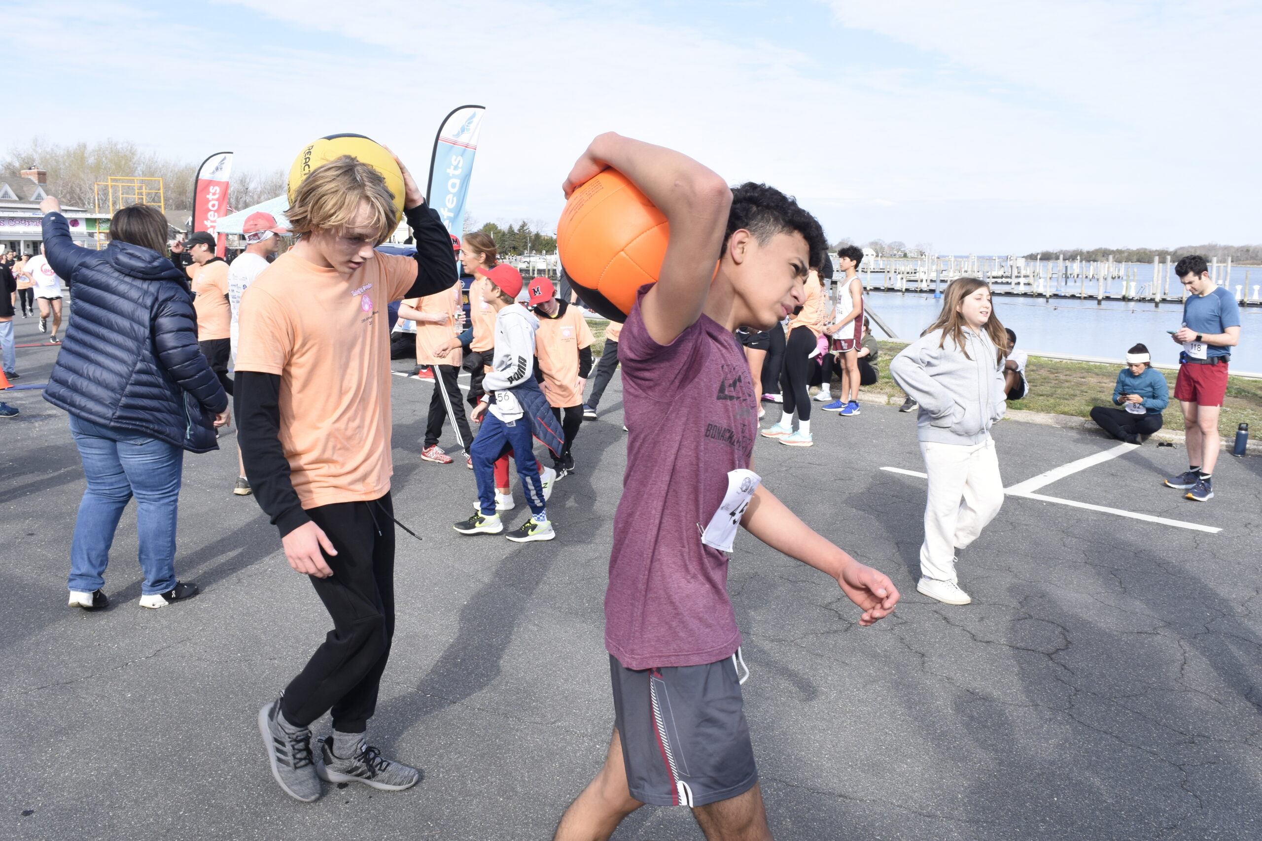 Cooper Ceva, left, and  of the East Hampton wrestling team ran with medicine balls.    DREW BUDD