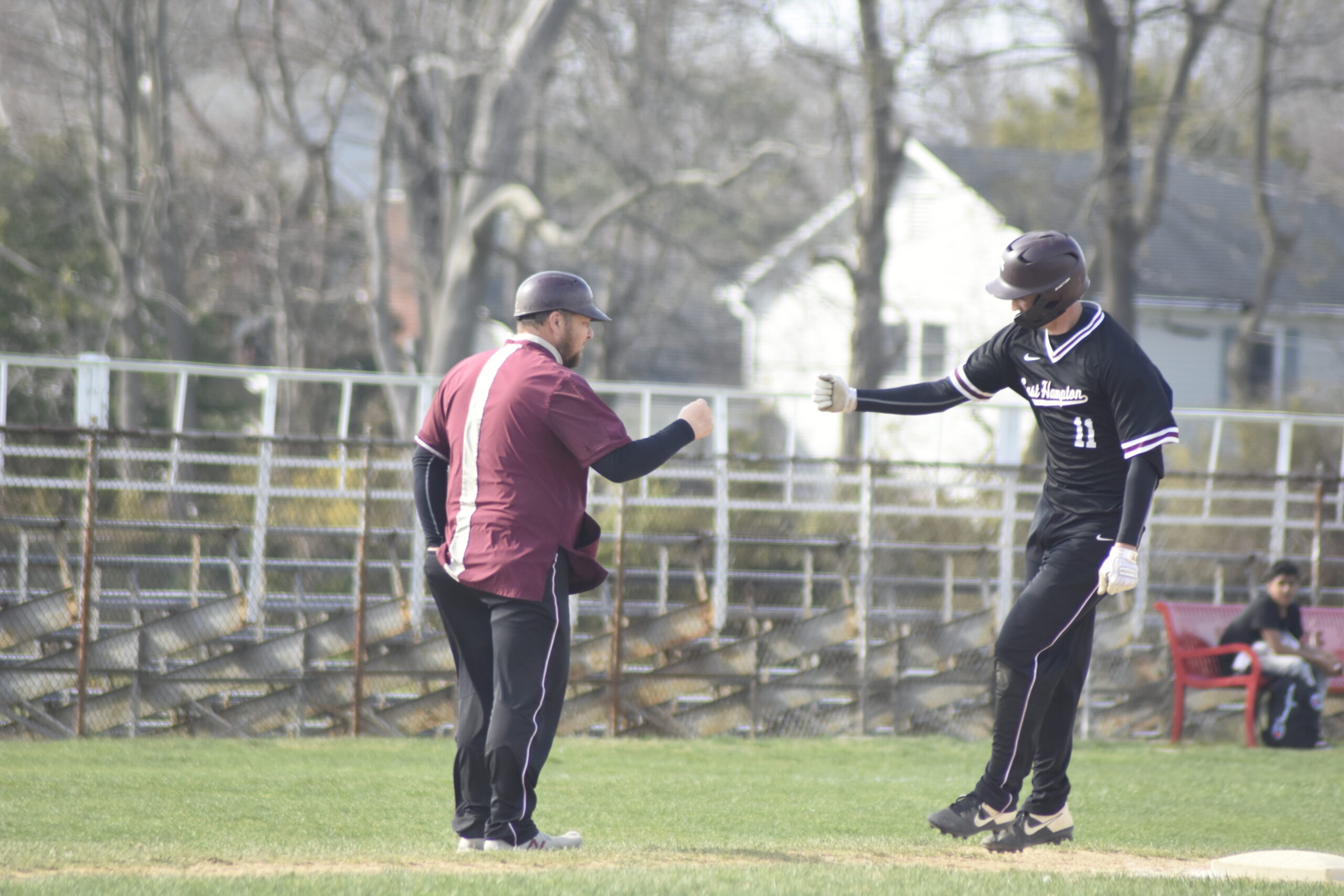 Avery Siska gets a congratulatory fist bump from head coach Vinny Alversa as he rounds third base on his grand slam.    DREW BUDD