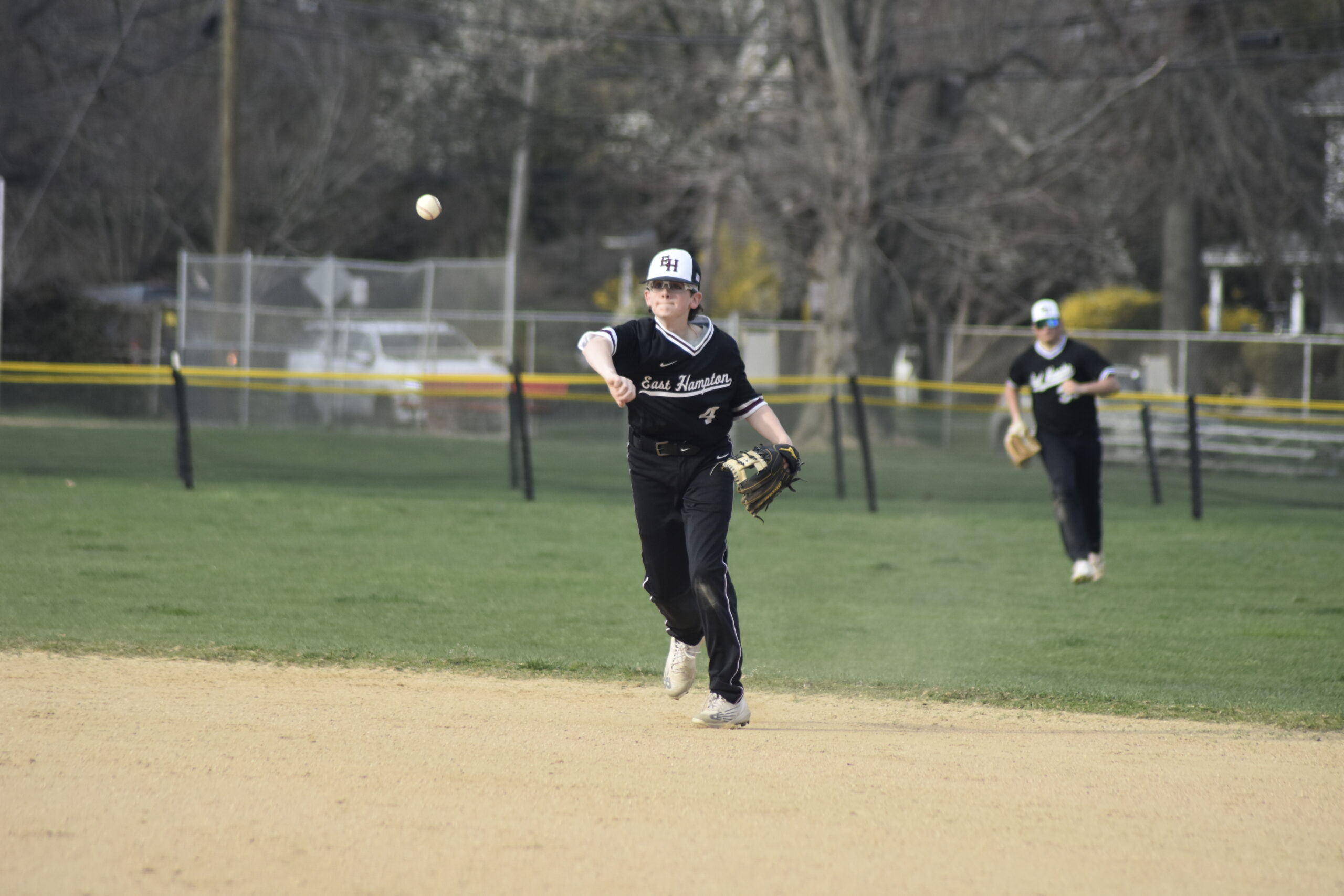 East Hampton second baseman Hudson Meyer throws to first for an out.   DREW BUDD