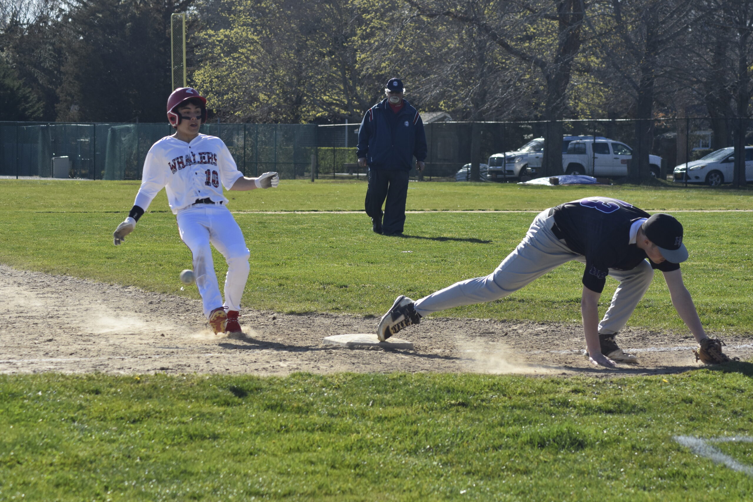Max Krotman pulls up to third base but then races home after the overthrow.   DREW BUDD