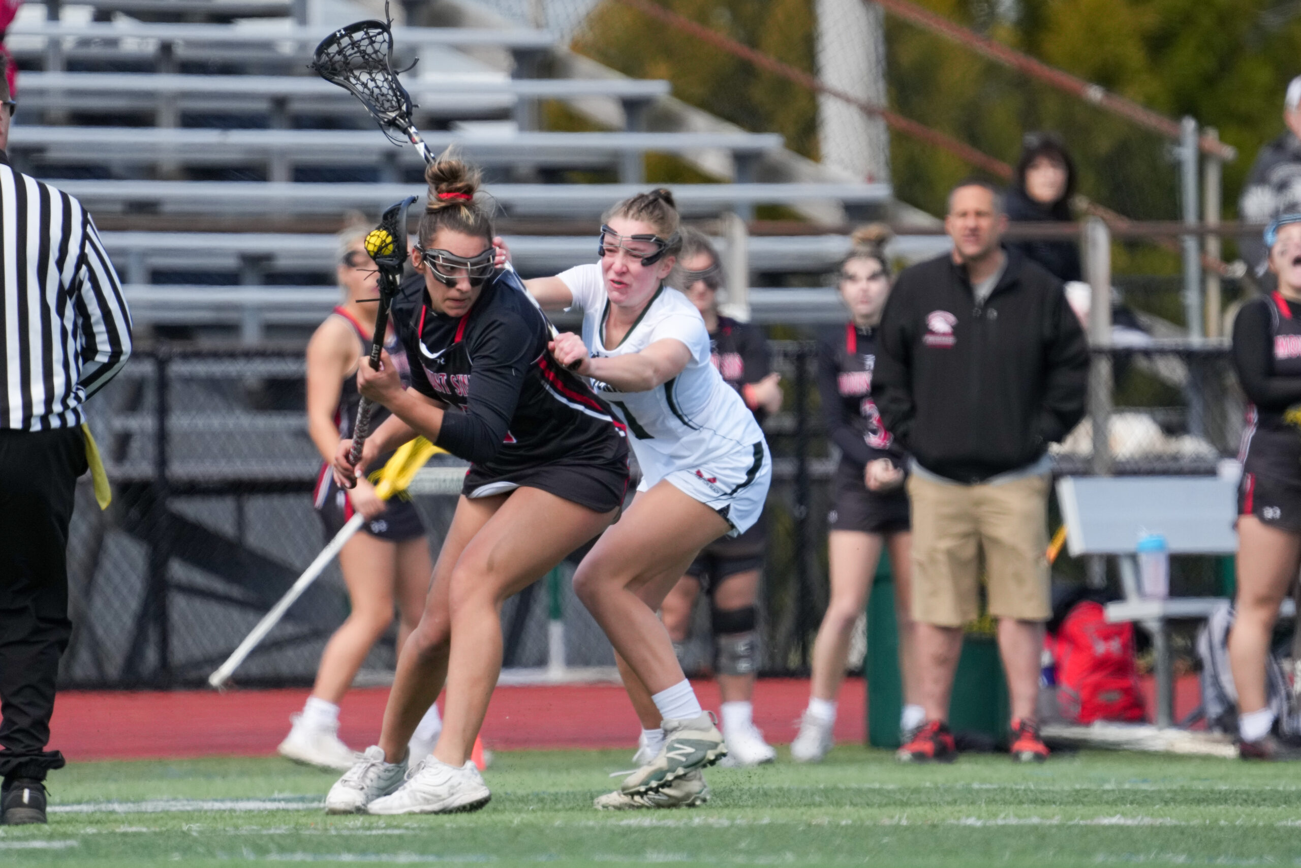 Senior attack Lily Berchin holds back a Mt. Sinai opponent. RON ESPOSITO