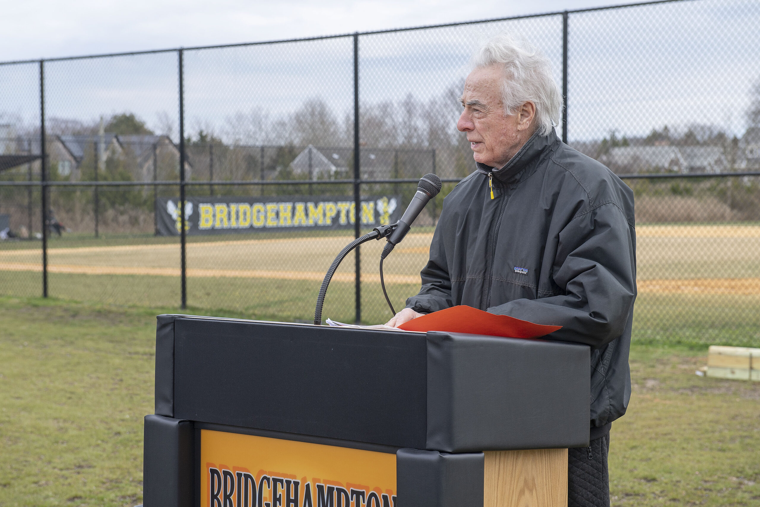 Dan Shedrick, a friend of baseball legend Carl Yastrzemski, reads aloud a message from the former Bridgehampton native during a dedication ceremony prior to the start of Tuesday's game.   MICHAEL HELLER