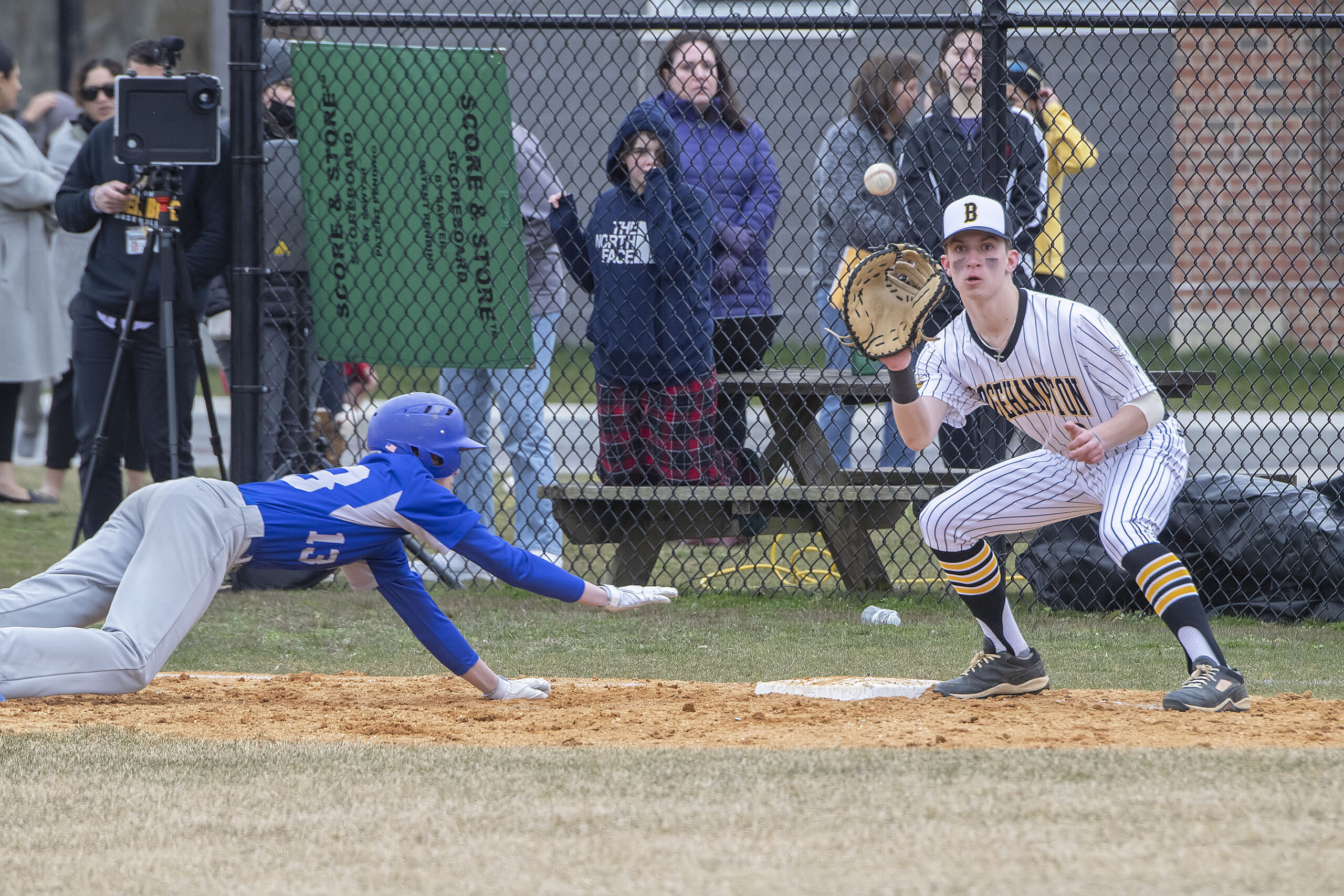 Bridgehampton first baseman Kristopher Vinski receives a throw from his twin brother Scott to try and pick off Shelter Island's Elijah Davidson.   MICHAEL HELLER