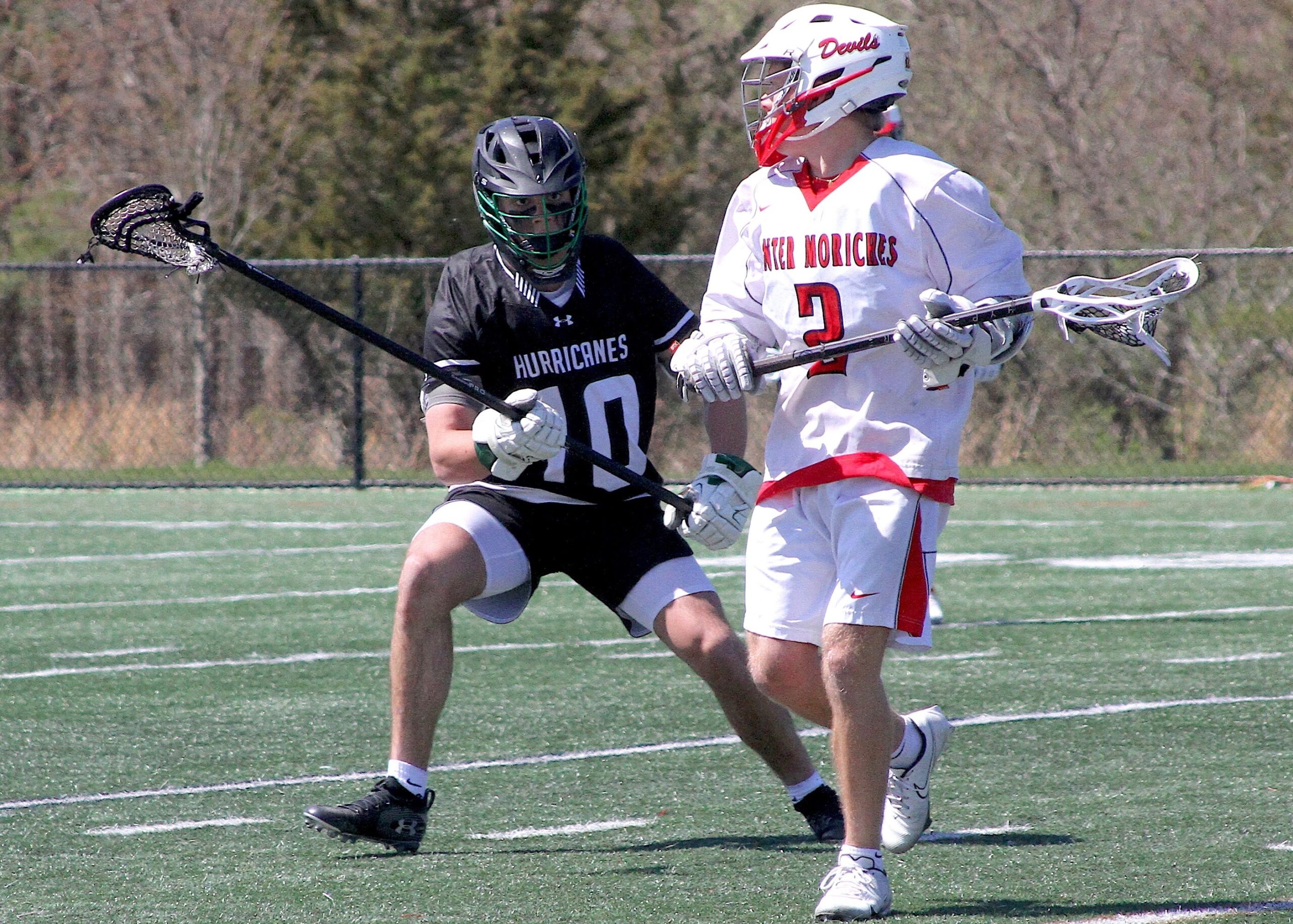 Senior longstick midfielder Christian Killoran keeps a Center Moriches attacker away from the cage. DESIRÉE KEEGAN