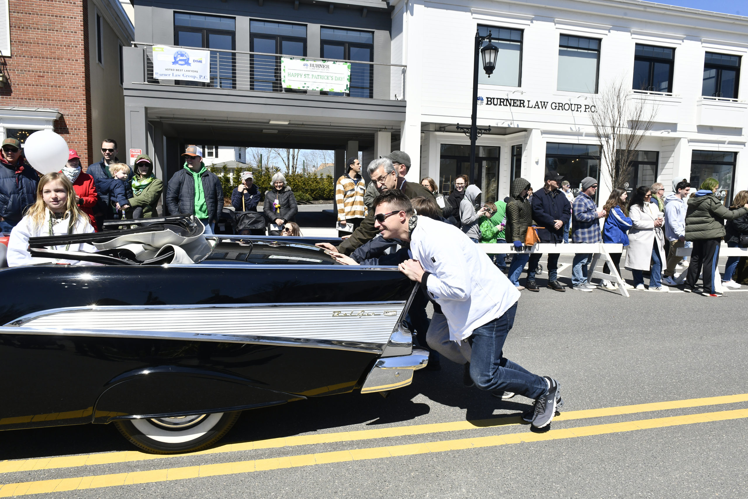 A Chevy Bel Air gets a push during the parade.