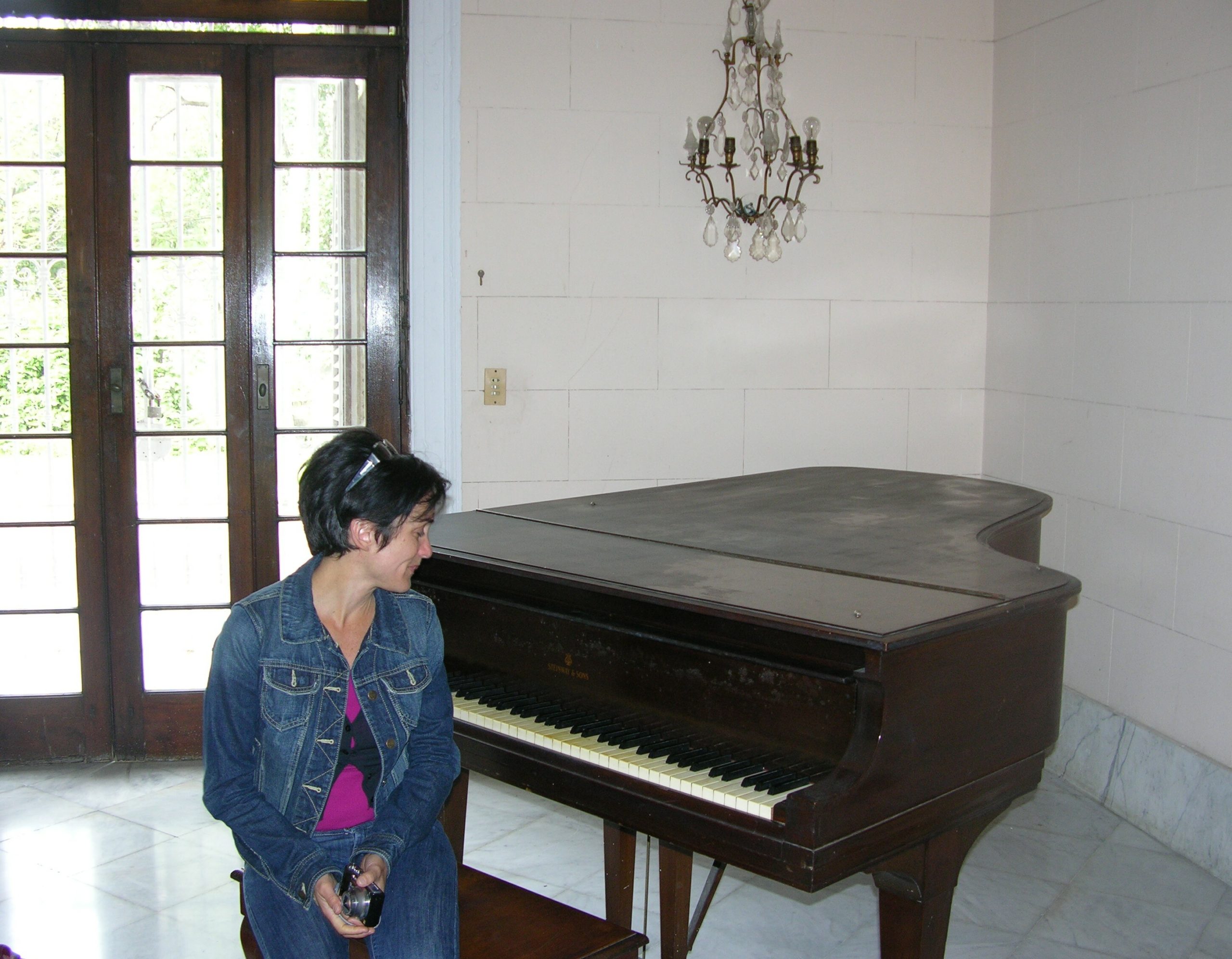 Adelaide Mestre in Cuba with the piano that once belonged to her late father, Luis Enrique Mestre. COURTESY ADELAIDE MESTRE