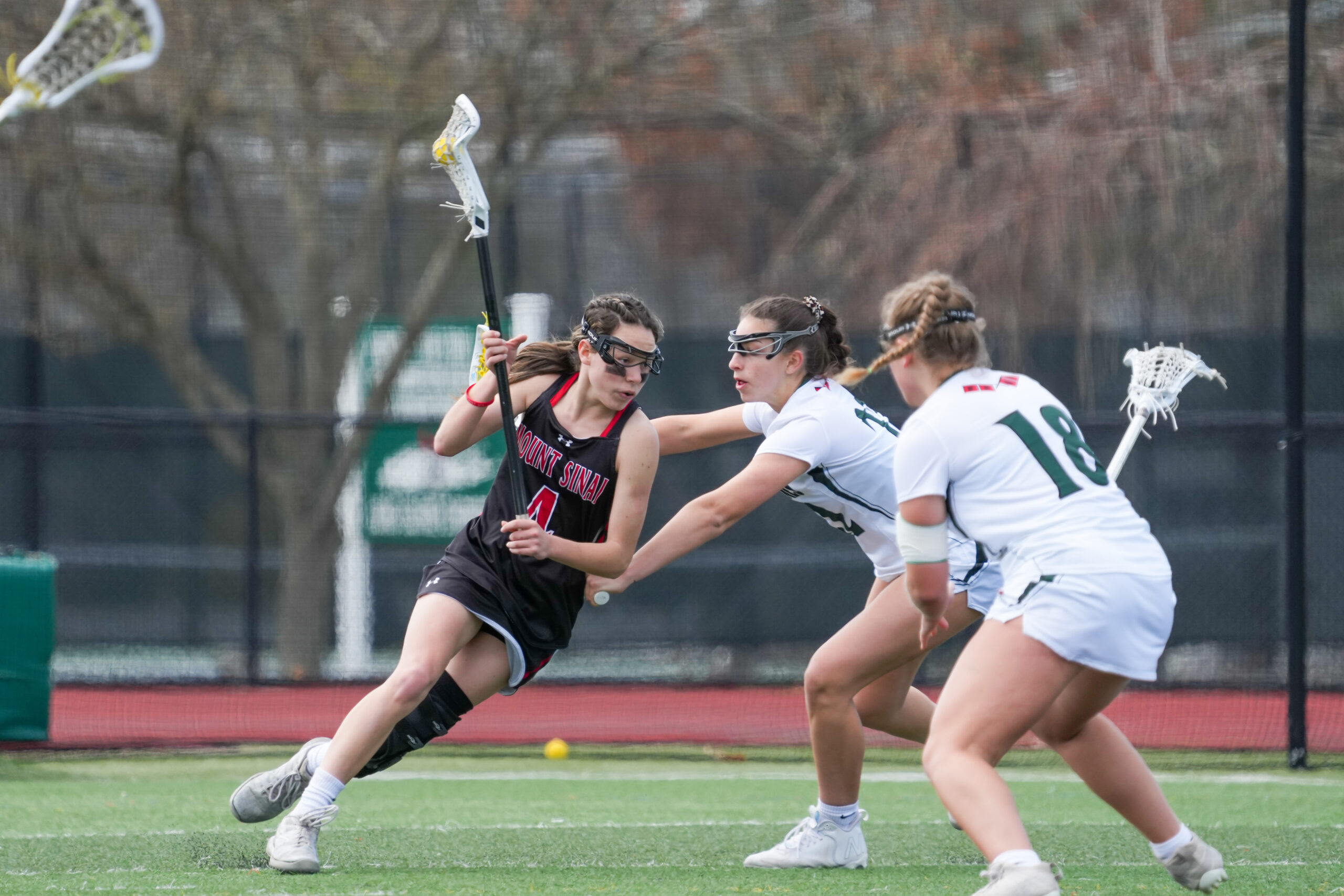 Senior Mia Failla and sophomore Chloe Mosher defend Westhampton Beach's zone against Mt. Sinai's Kylie Budke. RON ESPOSITO