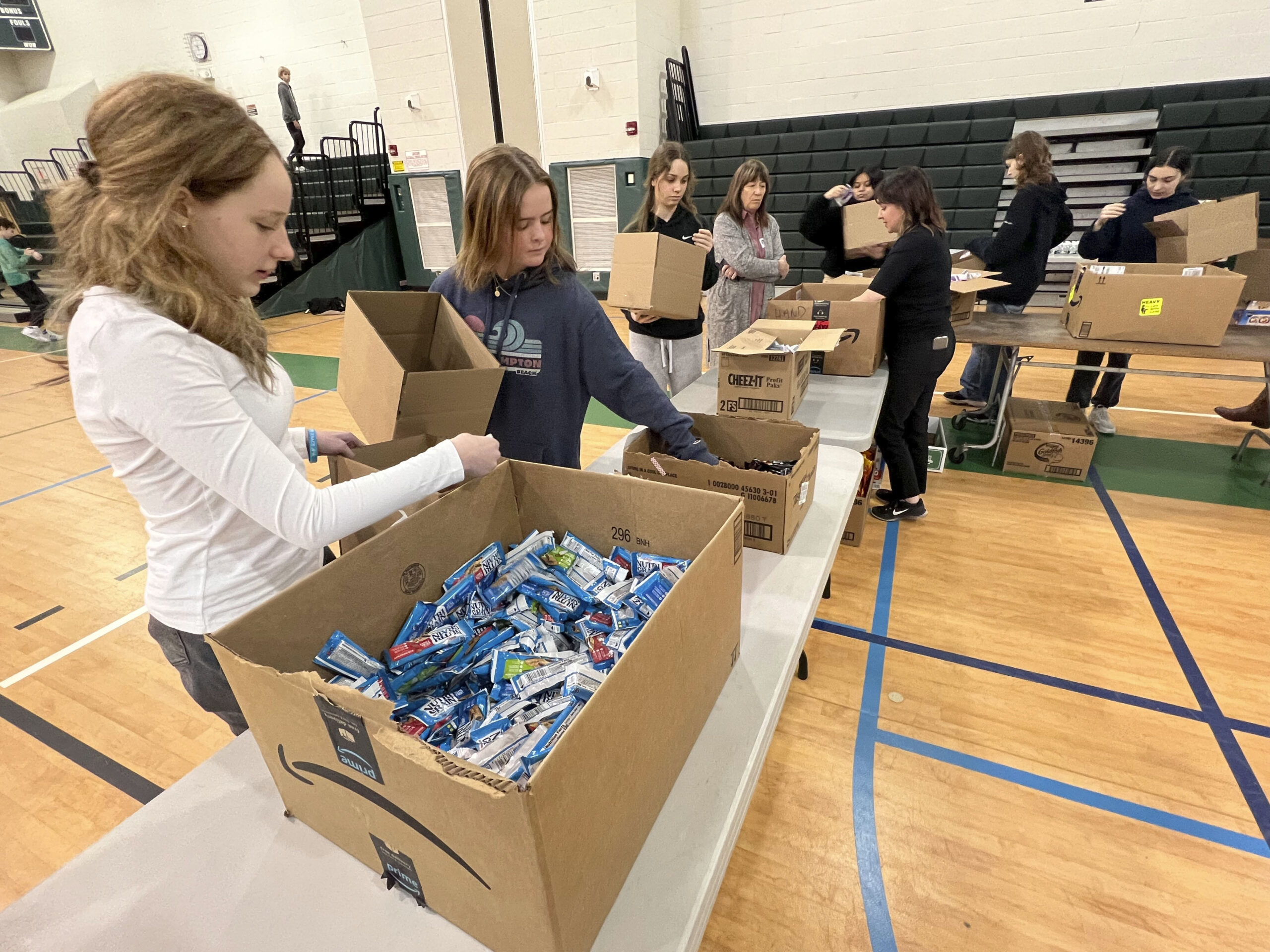 Students at Westhampton Beach Middle School put together care packages for the Ukraine Military on Thursday morning.  Over 1000 packages were made up on Wednesday and Thursday. The event coordinated by the school, Rocco A. Carriero Wealth Partners and iloveukraine.org.  DANA SHAW