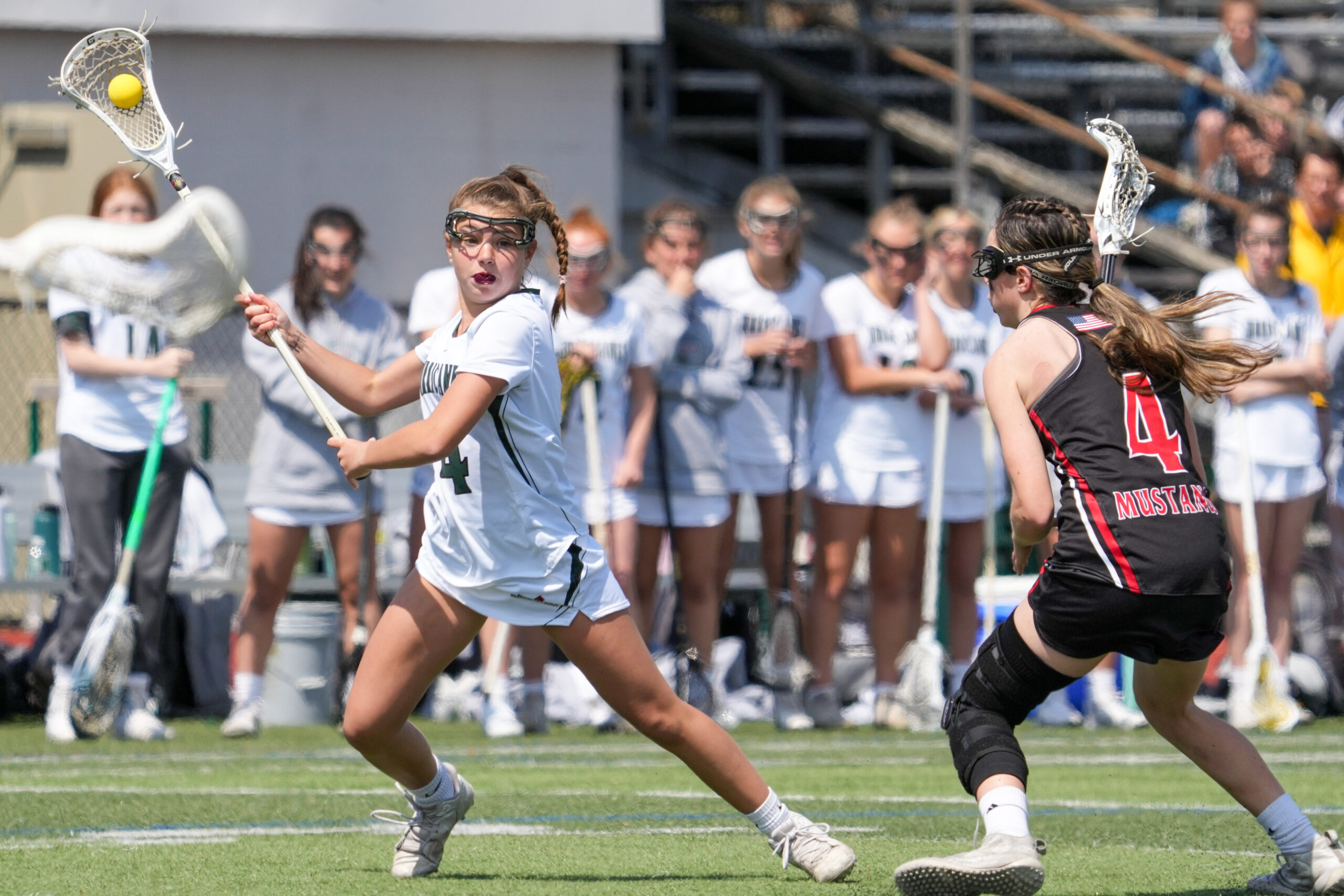 Freshman attack Brie Provenzano protects the ball from Mt. Sinai's Kylie Budke as she looks to make a play. RON ESPOSITO