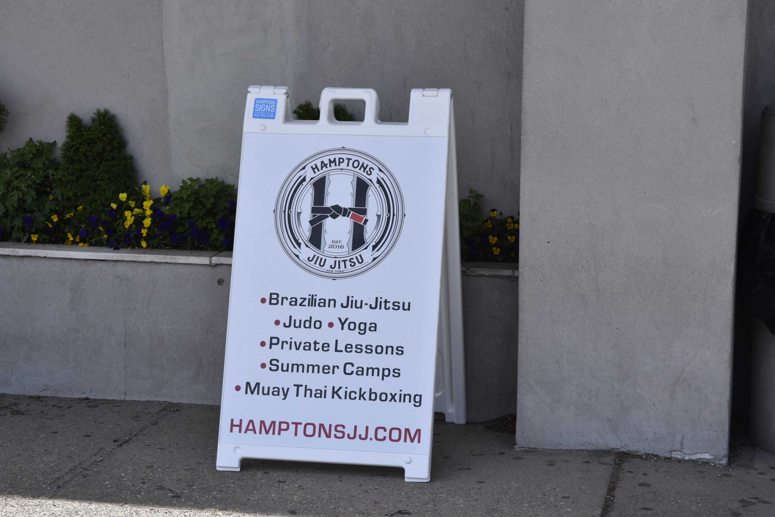 A sign at Hampton Jitney directing people to Hamptons Jiu-Jitsu, just steps away at Southampton Gym.   DREW BUDD