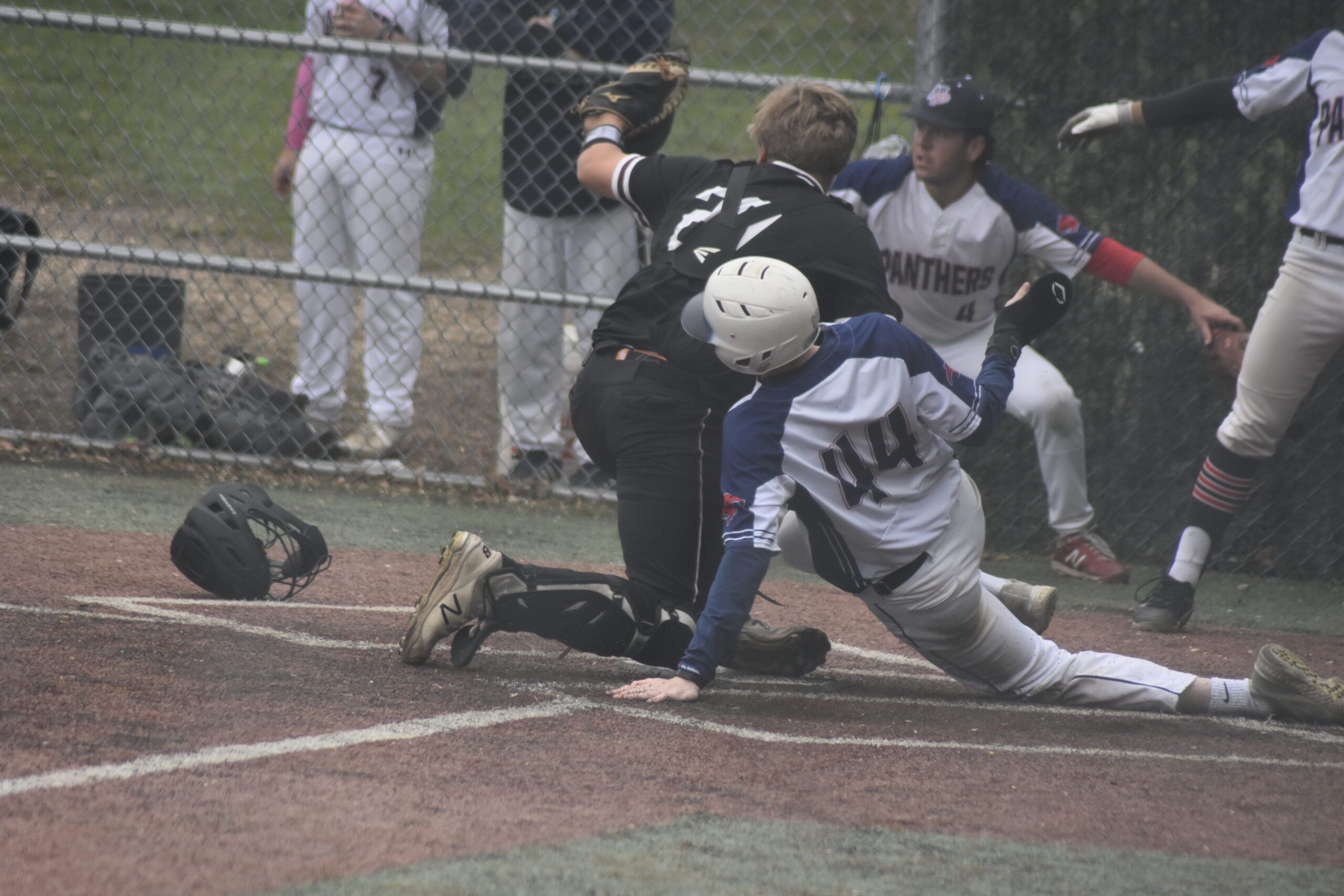 East Hampton freshman Carter Dickinson shows the umpire the ball after tagging out a Miller Place runner at the plate. Dickinson had received the strong throw from right fielder Michael Locascio.   DREW BUDD
