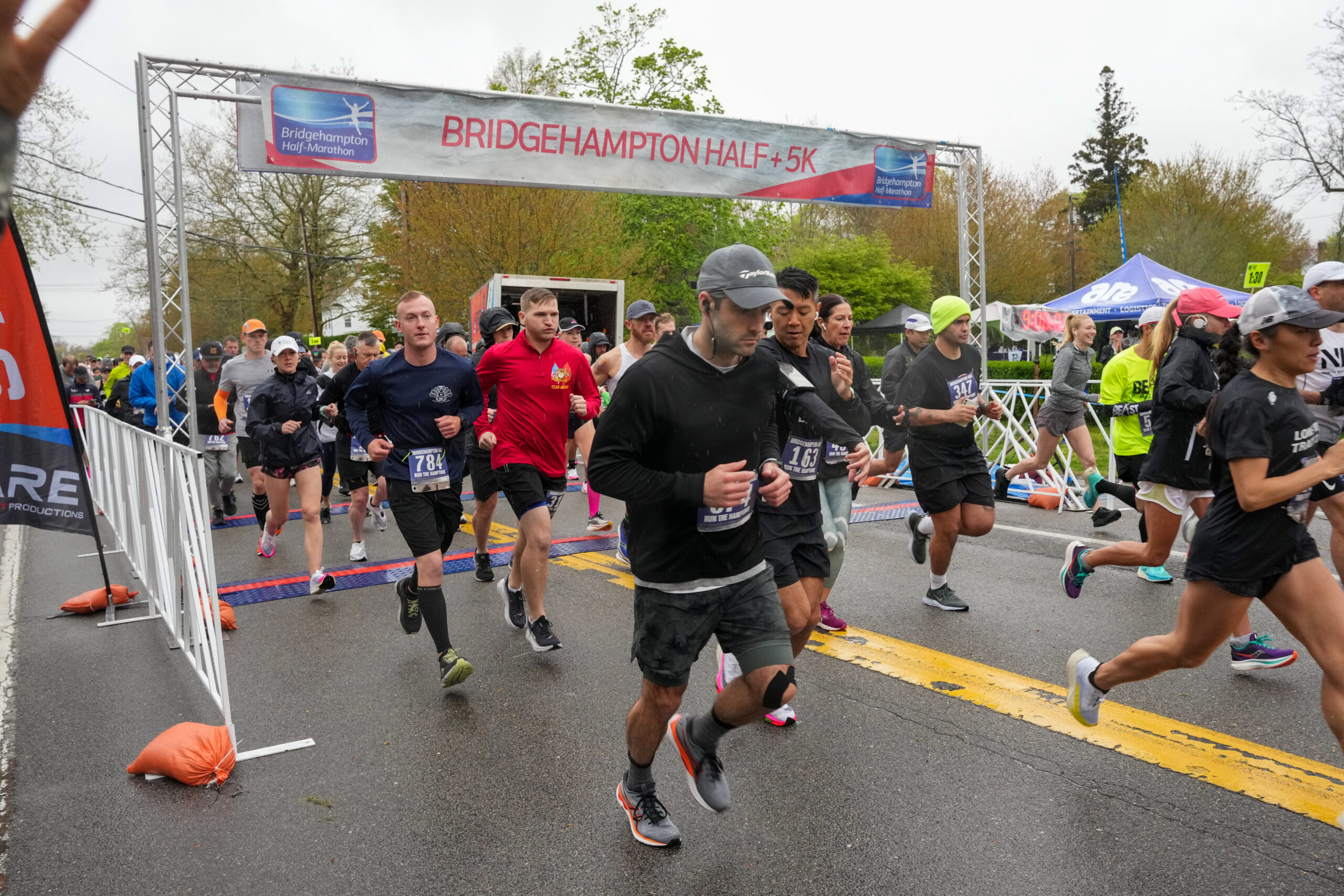 Runners start the seventh annual Bridgehampton Half-Marathon amid rainy and windy conditions on Saturday.  RON ESPOSITO