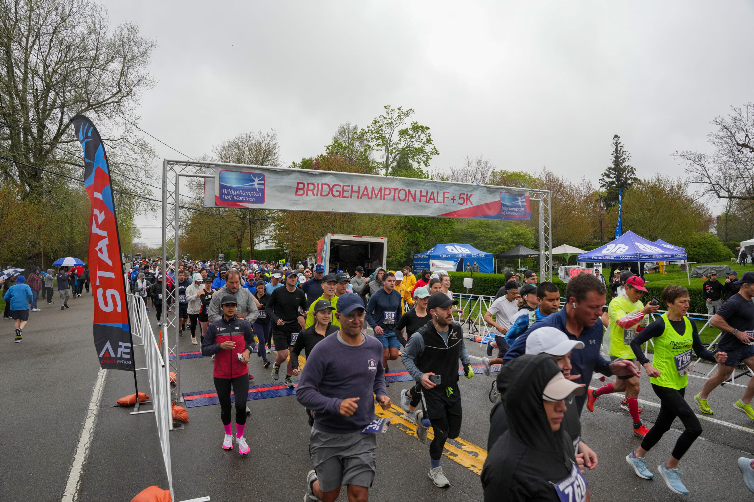 Runners start the seventh annual Bridgehampton Half-Marathon amid rainy and windy conditions on Saturday.  RON ESPOSITO