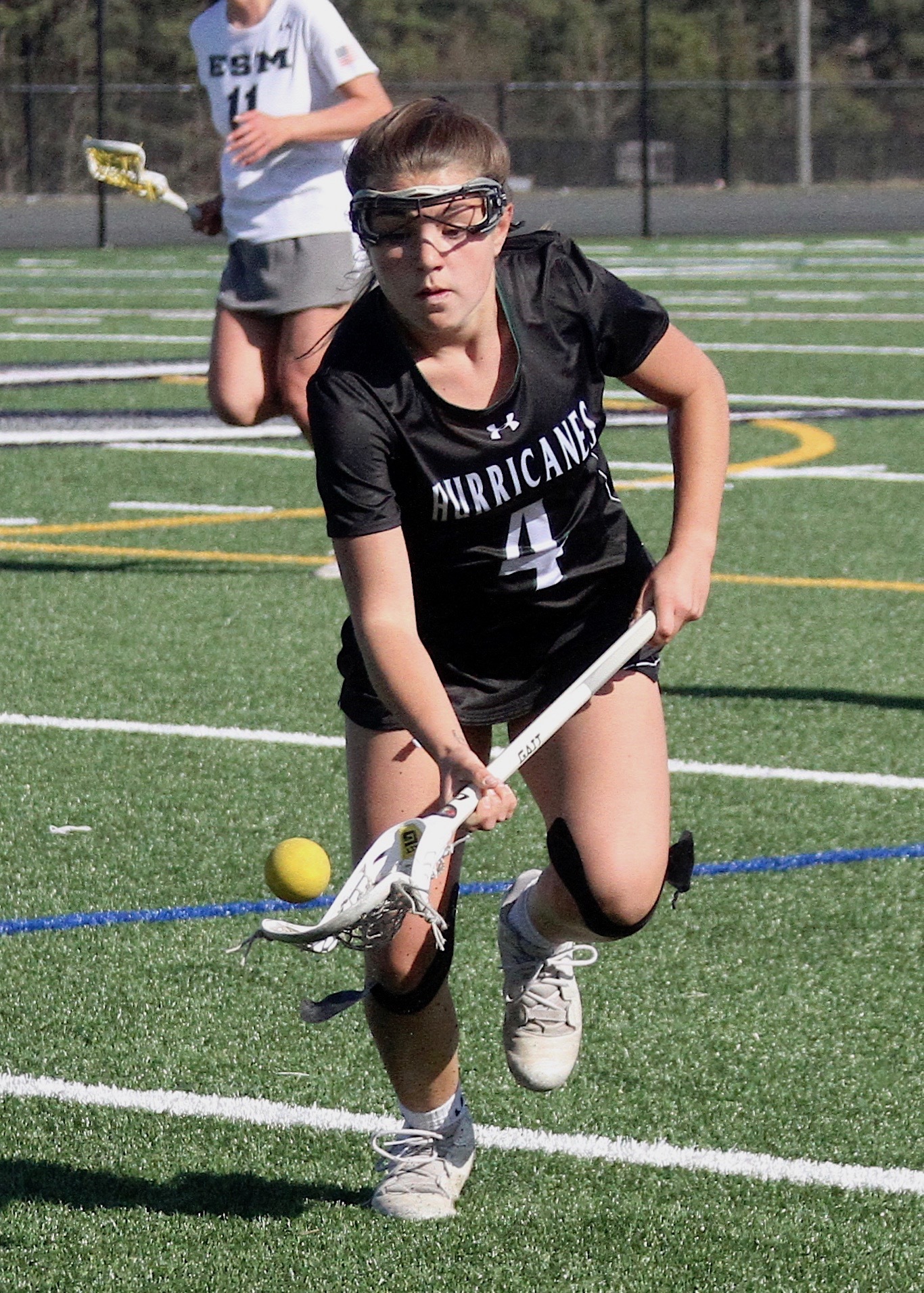 Freshman attack Brie Provenzano scoops up a loose ball. DESIRÉE KEEGAN