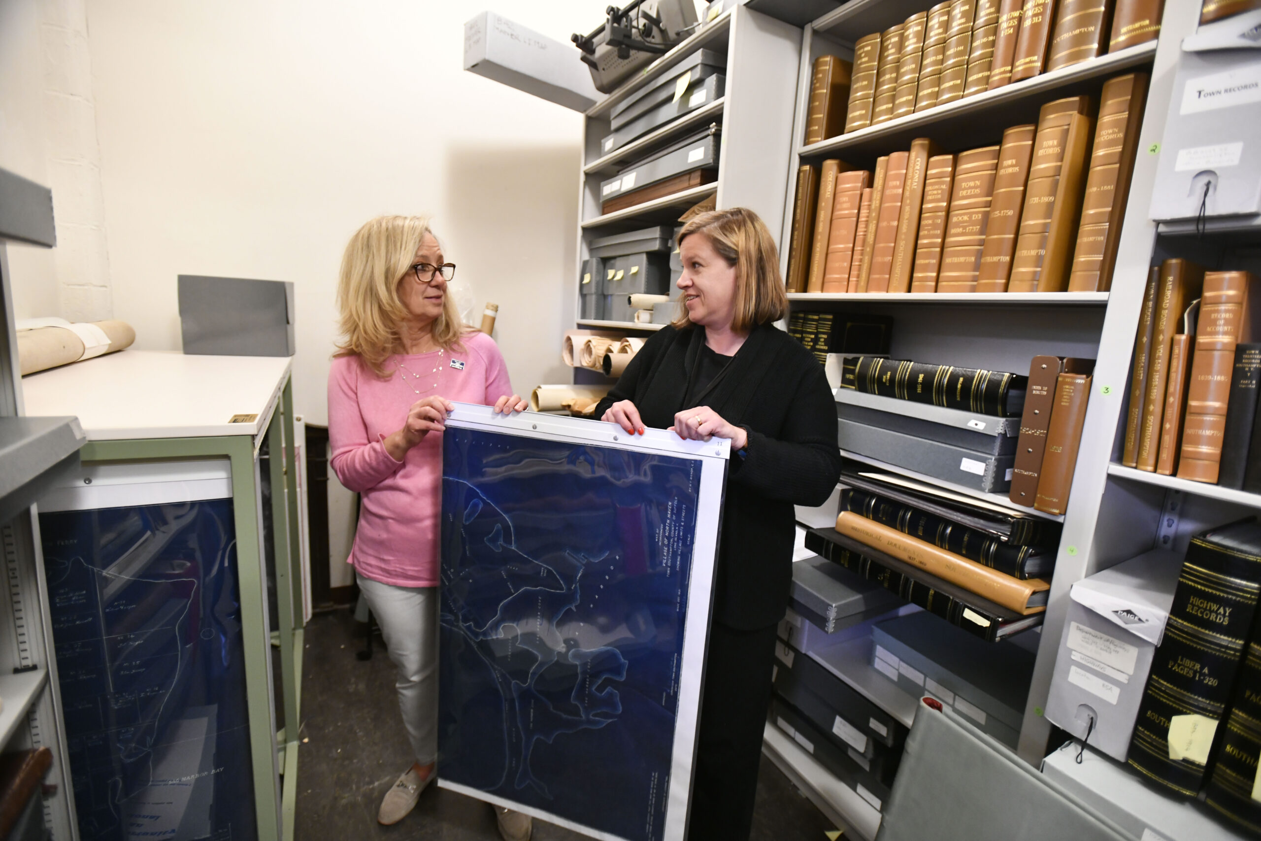 Julie Greene and Sundy Schermeyer with the maps that have protected and archived.  DANA SHAW