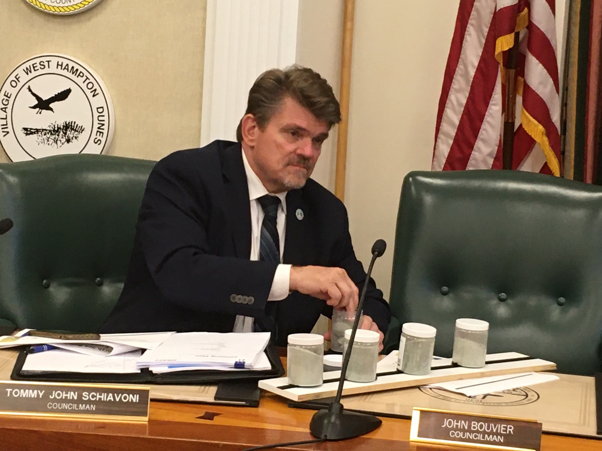 Councilman Tommy John Schiavoni examines olivine  samples during the hands on portion of the Southampton Town Board work session.