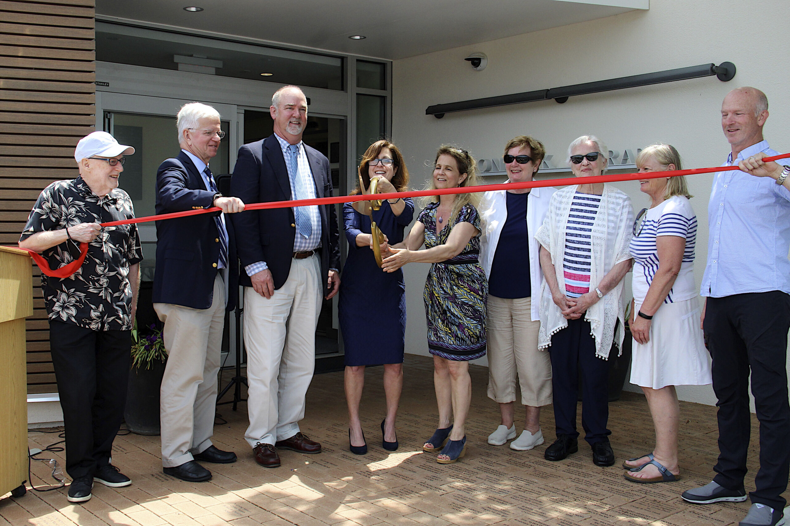 Richard Sheckman, Fred Thiele, Peter Van Scoyoc, Denise DiPaolo, Barbara Grimes, Linda Barnds, Linda Bostrom,  Marilyn Levine and Carter Tyler cut the ribbon on the renovation and expansion project at the Montauk Library on Sunday.    KYRIL BROMLEY