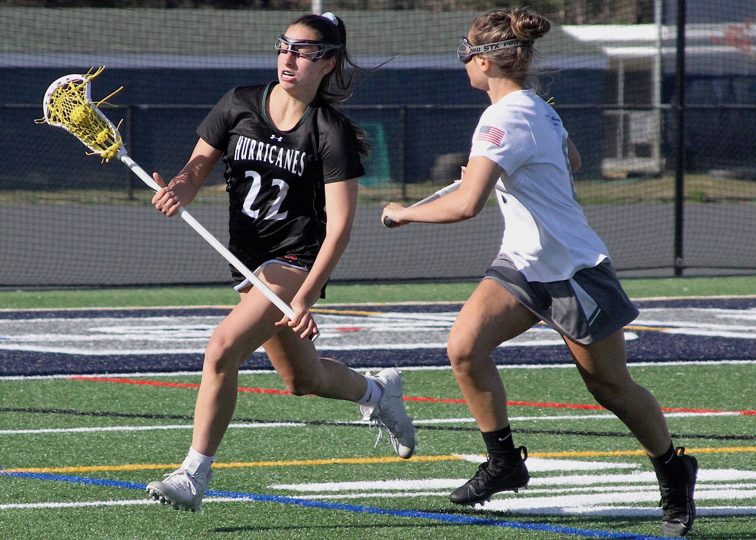 Senior defender and midfielder Mia Failla carries the ball out of Eastport-South Manor's zone after scooping up a ground ball. DESIRÉE KEEGAN