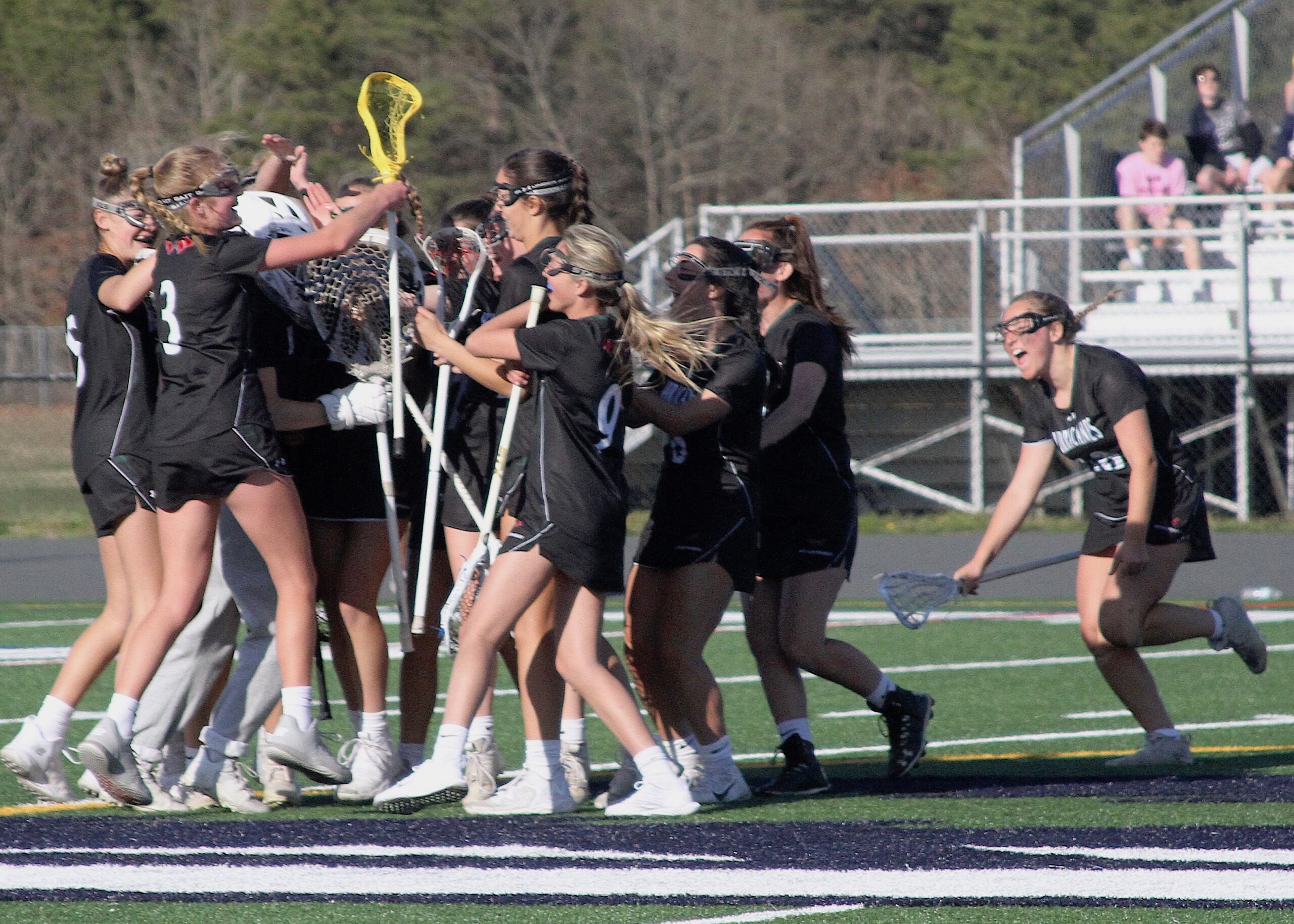 Westhampton Beach's girls lacrosse team celebrates its first win over Eastport-South Manor. DESIRÉE KEEGAN