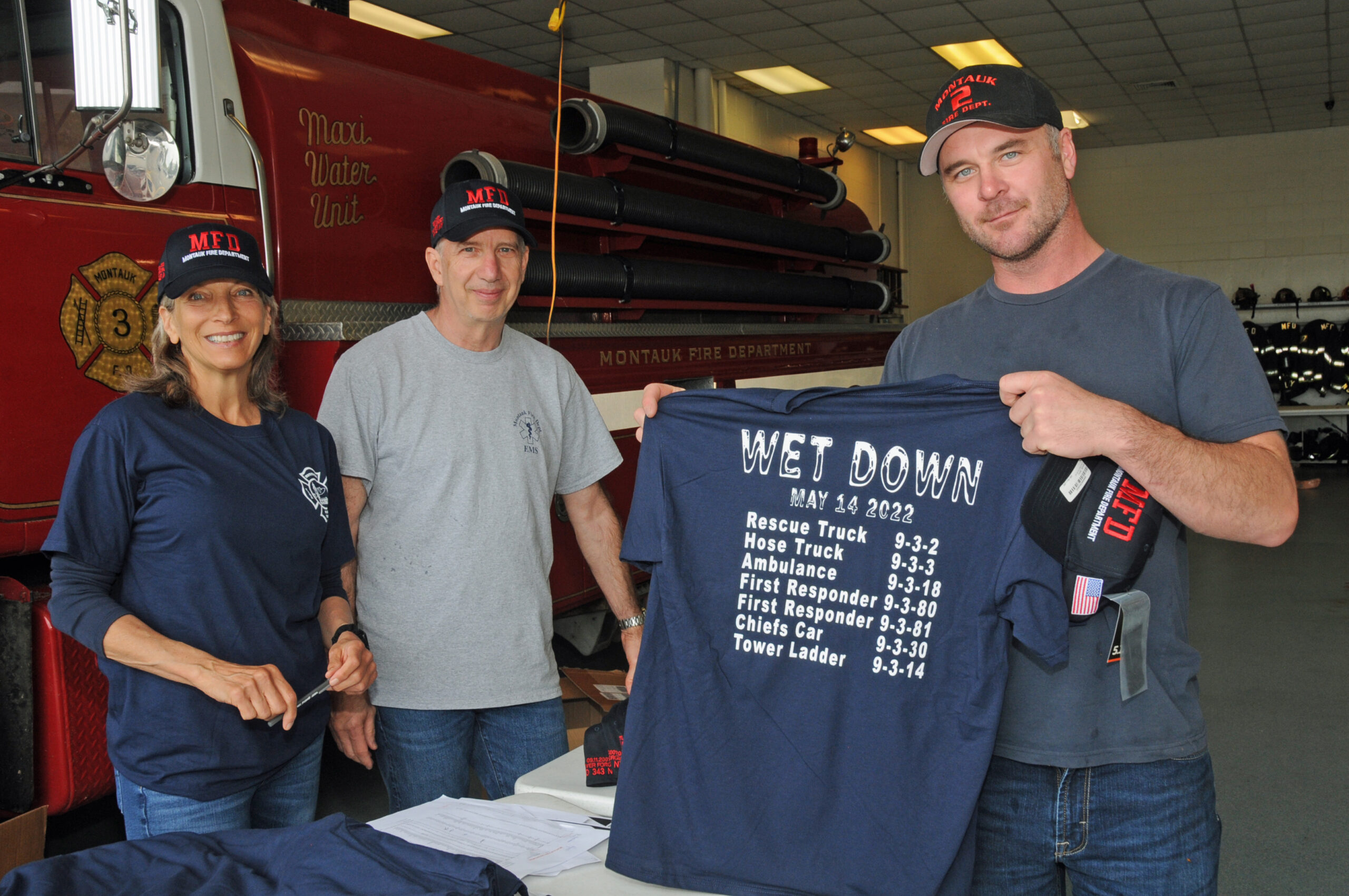 Joy Hear, Robert Freyberg and Kyle Fagerland at the  Montauk Fire Department, Wet-Down of seven trucks and emergency vehicles on Saturday.   RICHARD LEWIN