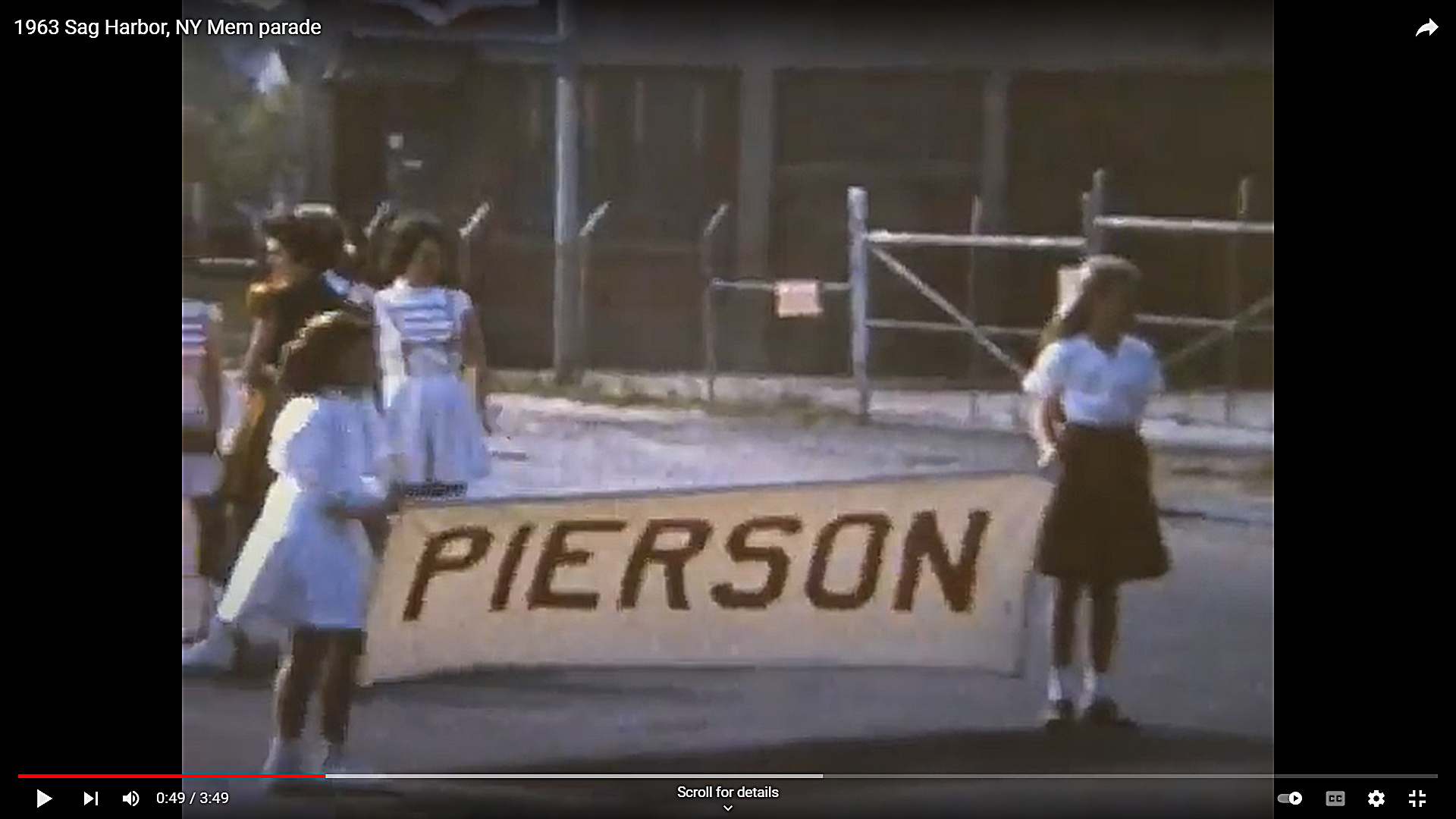 Girls hold a banner announcing the Pierson High School Band at the beginning of the Sag Harbor Memorial Day parade.