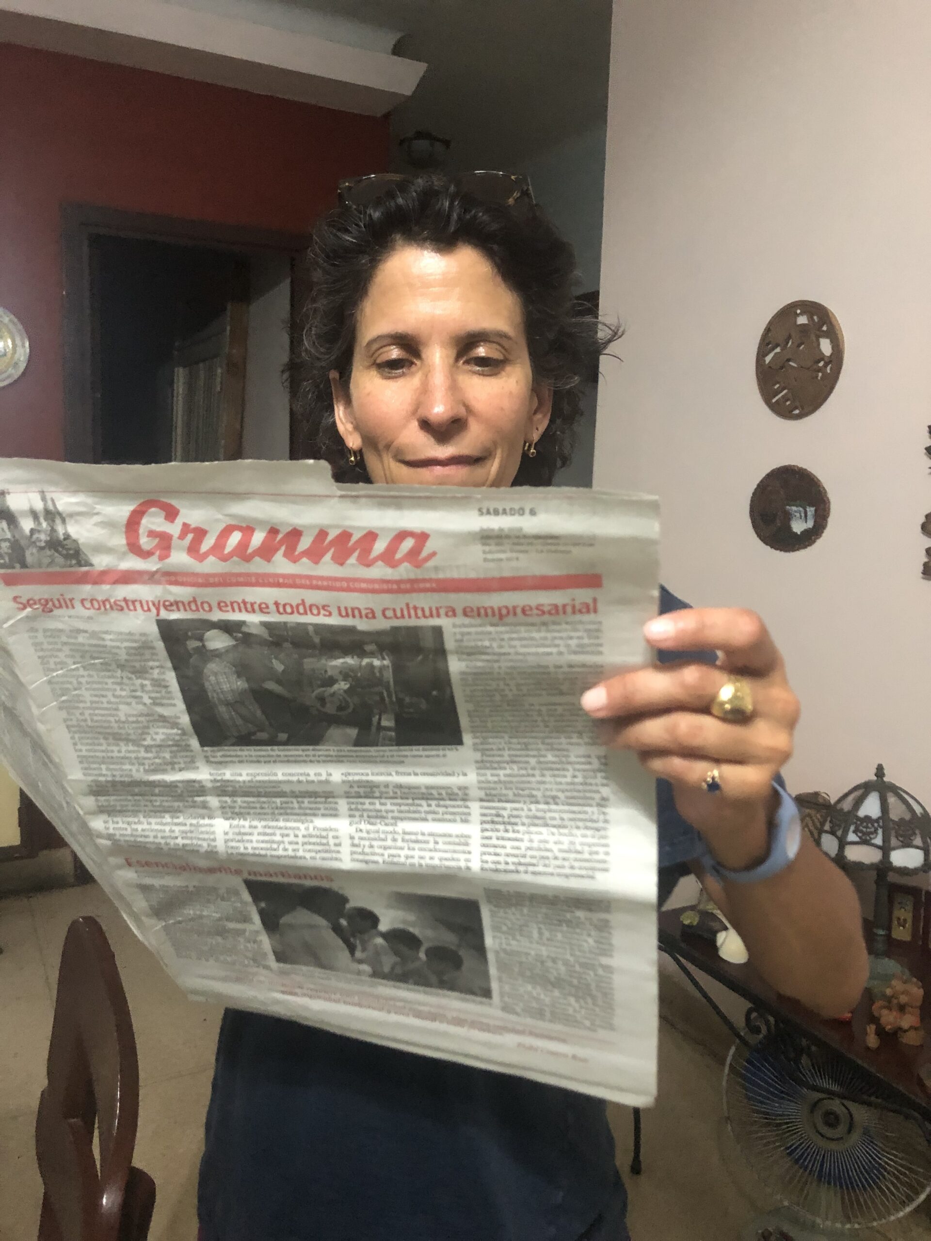 Christiane Arbesu on location in Cuba with a copy of the newspaper Gramma. COURTESY THE ARTIST