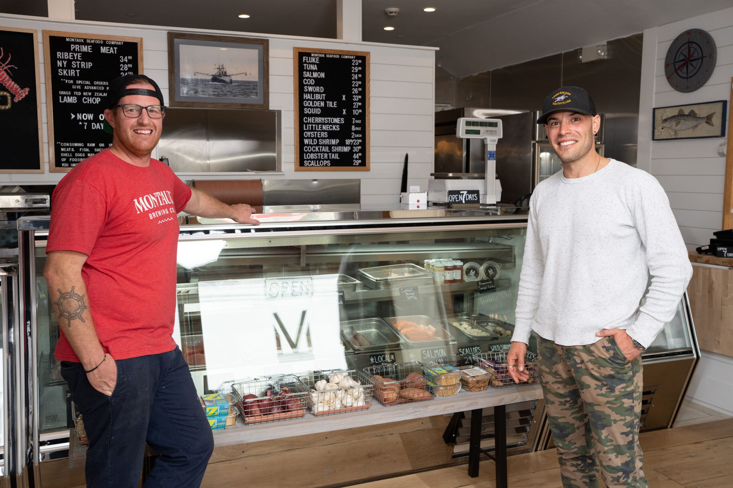Wesley Peterson (L) and Douglas Davidson co-owners of Montauk Seafood Company in their shop in Montauk, New York. 