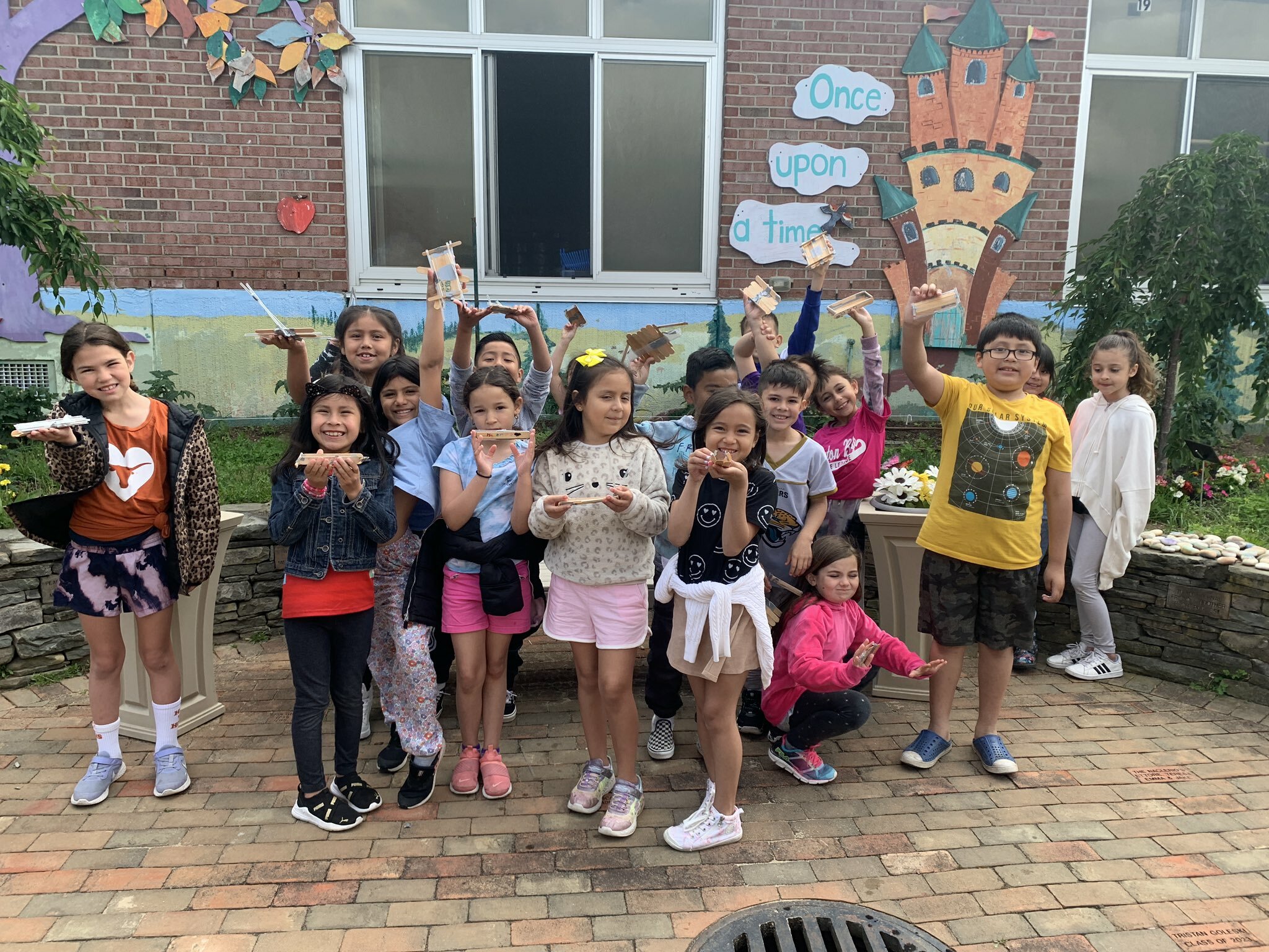 As part of their science, technology, engineering and math curriculum, second grade students at Hampton Bays Elementary School recently tested their engineering skills by constructing boats in the school’s STEM lab. They built the boats using Popsicle sticks, straw and duct tape and tested their inventions to see how many marbles they could carry while floating in a kiddie pool. COURTESY HAMPTON BAYS SCHOOL DISTRICT