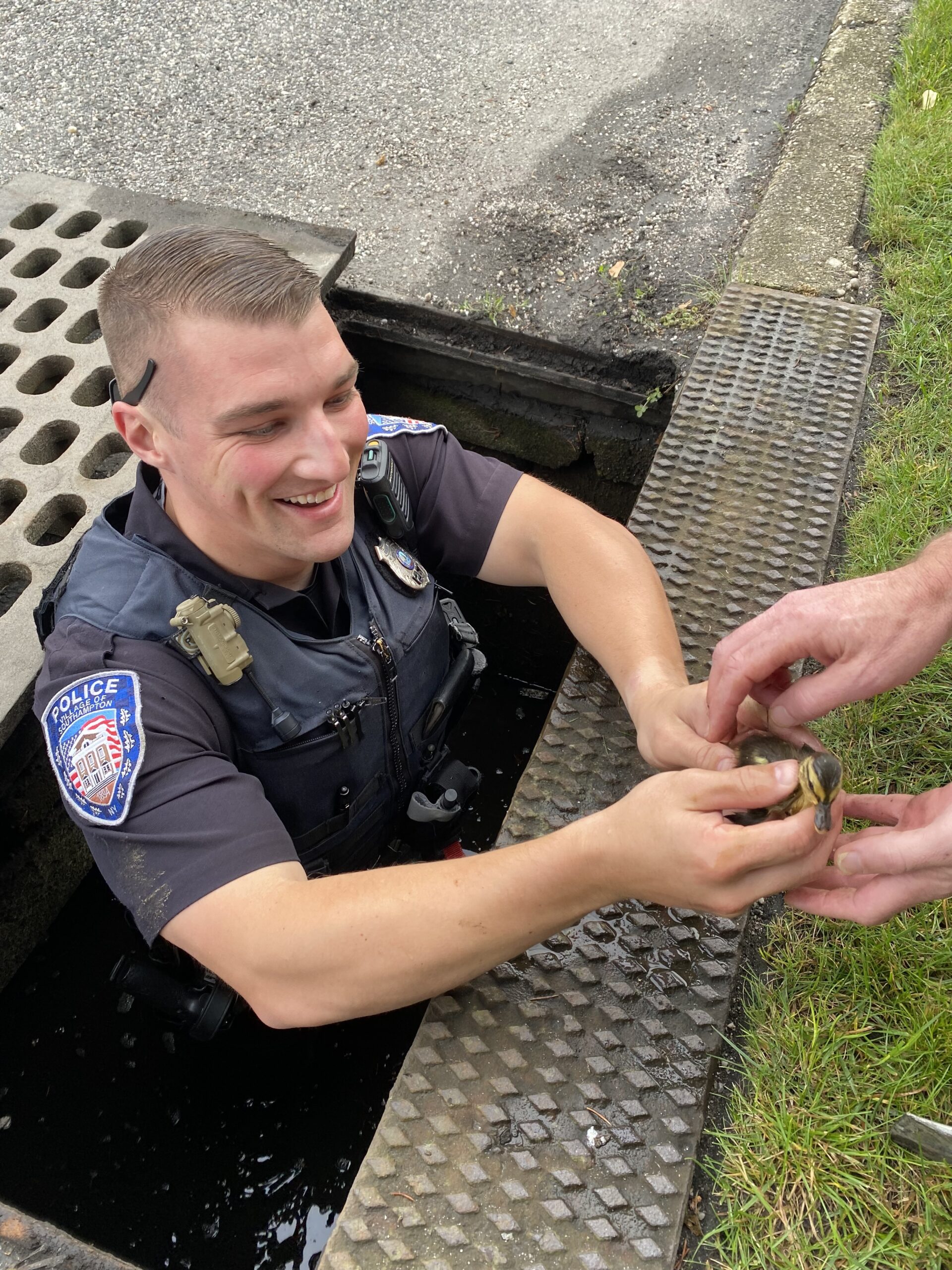 Officer Kyle McGuinness with one of the rescued ducklings.
