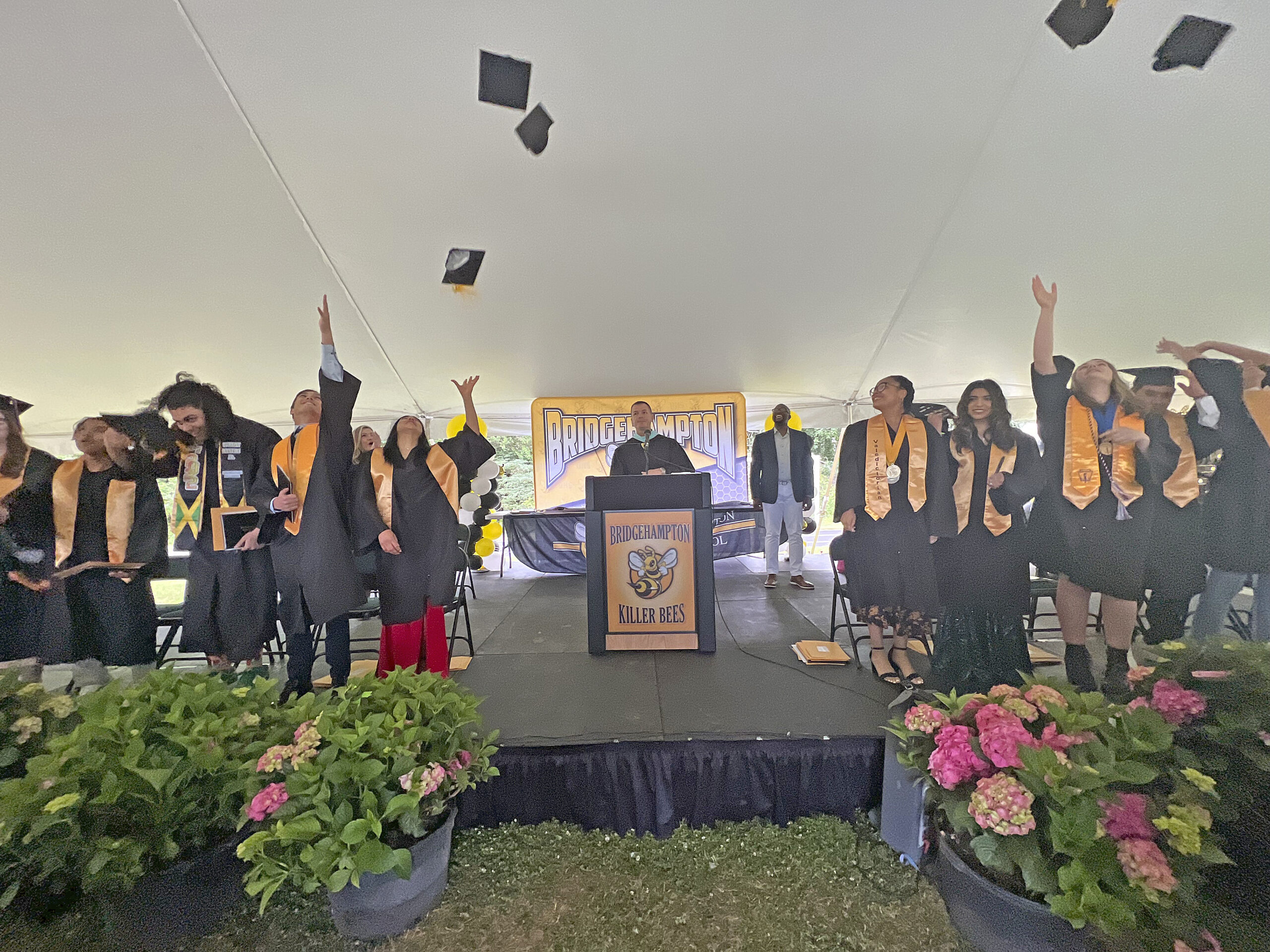 The Bridgehampton High School Class of 2022 toss their caps after graduation.
